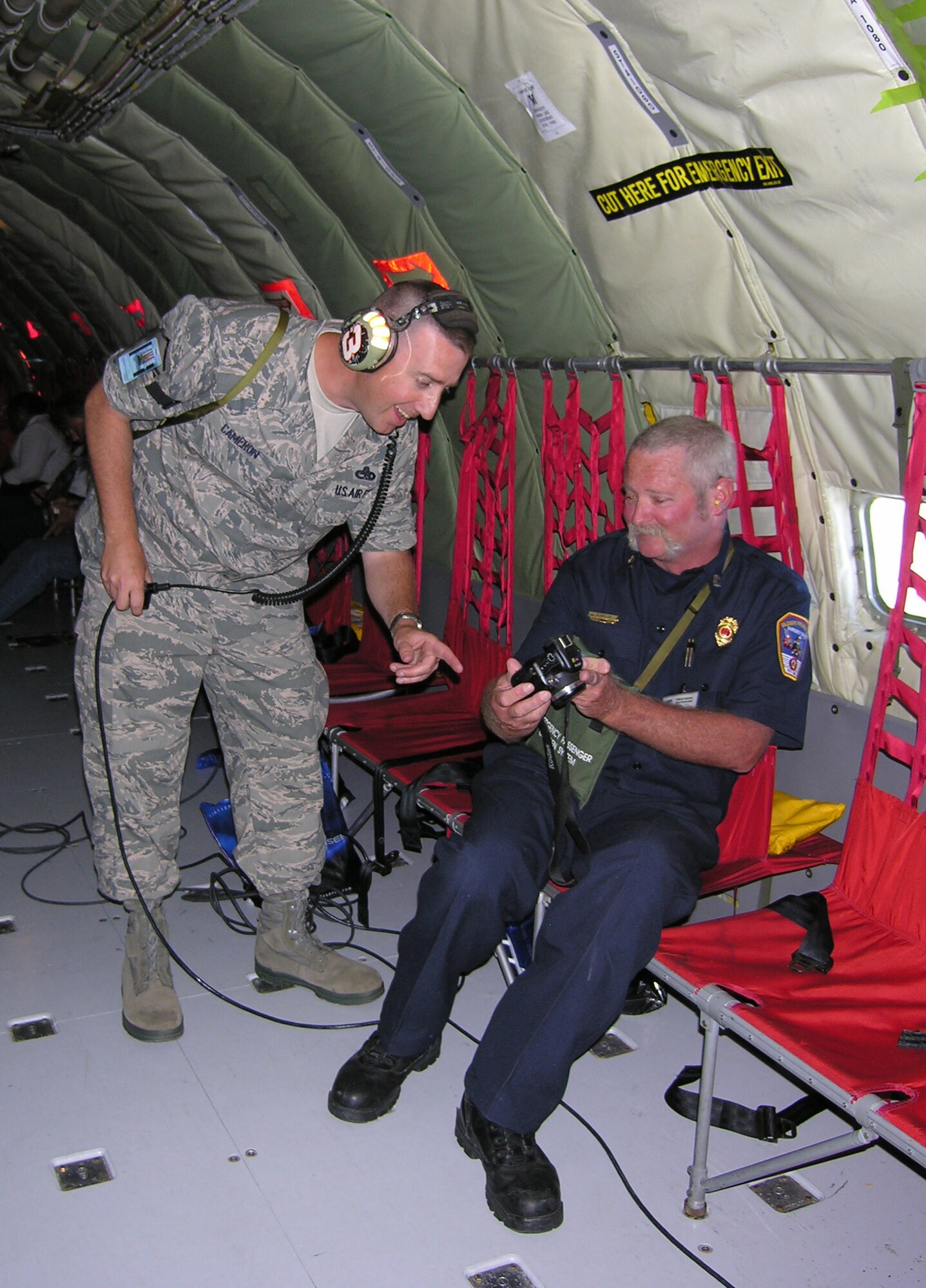 SEYMOUR JOHNSON AIR FORCE BASE, N.C. -- Master Sgt. Kevin Cameron (left) looks at photos taken by Goldsboro Fire Department Capt. Jon Gillis. Capt. Gillis was part of a civic leader flight that took place here on June 1. Sgt. Cameron is a Reservist with the 916th Maintenance Operations Flight.