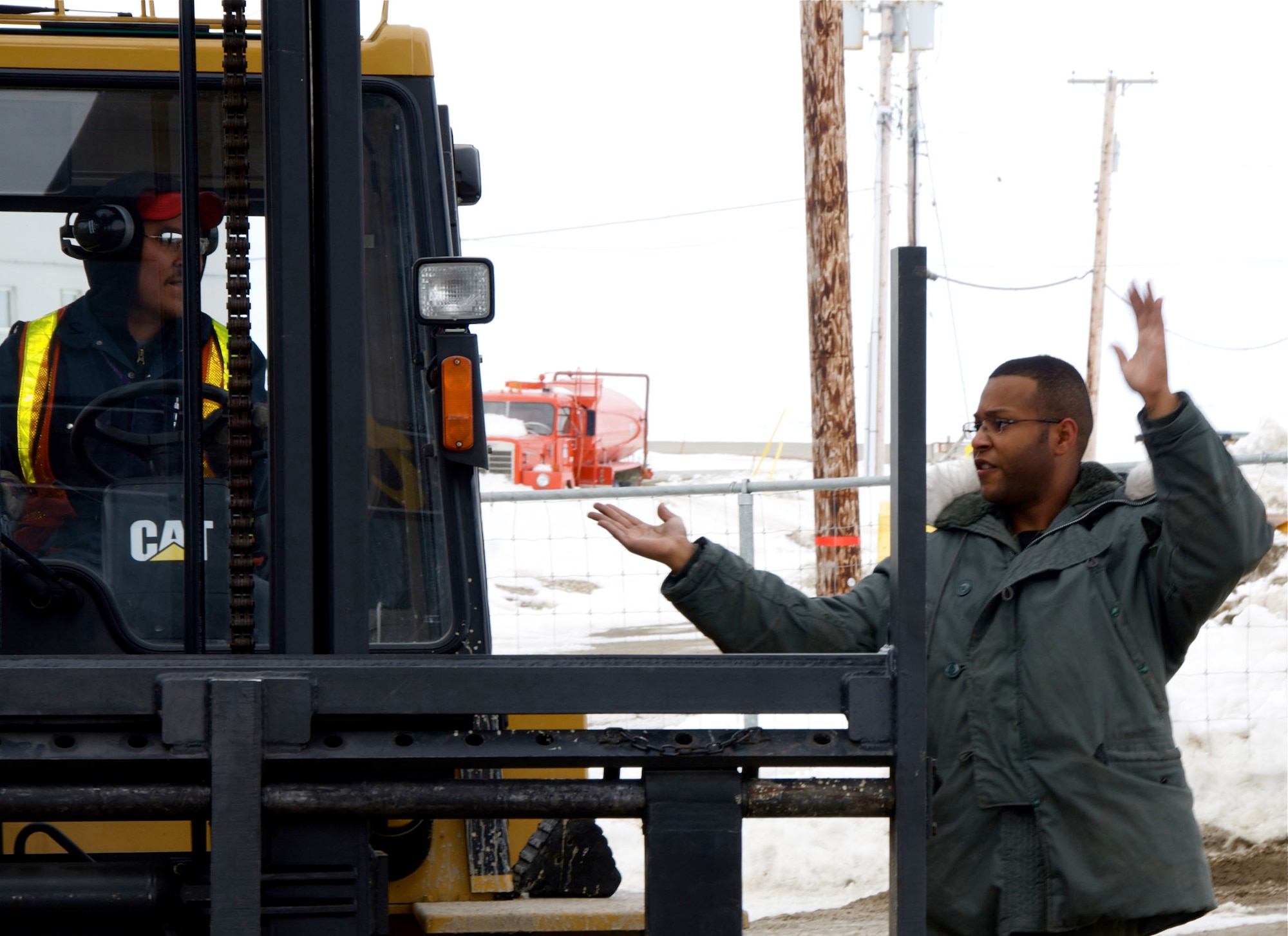 Staff Sgt Marcus Allen, a 109th Airlift Squadron Loadmaster, directs a civilian forklift being used to unload a 133rd Airlift Wing, Minnesota Air National Guard C-130 Hercules cargo aircraft in Cambridge Bay, Canada on May 27, 2009. The C-130 is delivering much needed supplies and providing transportation of vital equipment to support the Haughton-Mars Project (HMP) in Resolute, Canada. HMP supports an exploration program aimed at developing new technologies, strategies, human's factors experience, and field-based operational know-how key to planning the future exploration of the Moon and Mars.
U.S. Air Force Photo by Tech Sgt Erik Gudmundson