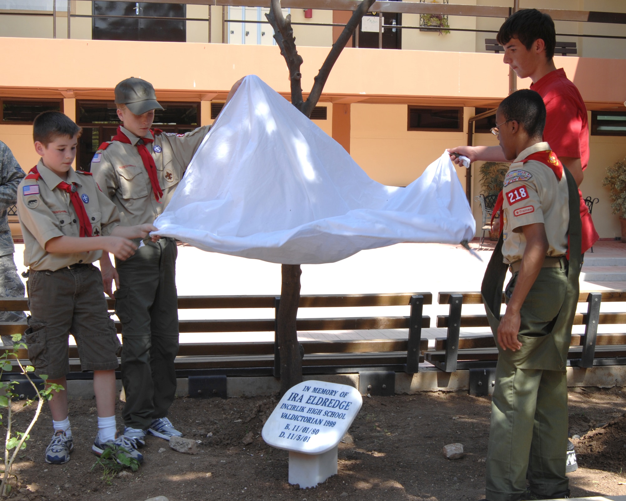 Members of Boy Scout troop 218 unveil the Ira Eldridge memorial marker Wednesday, June 3, 2009 during the Ira Eldridge Memorial Re-dedication ceremony at Incirlik Unit School, Incirlik, Air Base, Turkey. The troop honored the memory of Eagle Scout Eldridge who died in 2001 of leukemia. Ira Eldridge was also the class of 1999 valedictorian at Incirlik Unit School, vice president of the Incirlik Unit School National Honor Society and a member of the varsity soccer team. A memorial plaque was placed on school grounds, but fell into disrepair over the years. The scouts decided it needed to be resurrected and placed in a more prominent location so current and future generations would not forget him. (U.S. Air Force photo/ Staff Sgt. Lauren Padden)