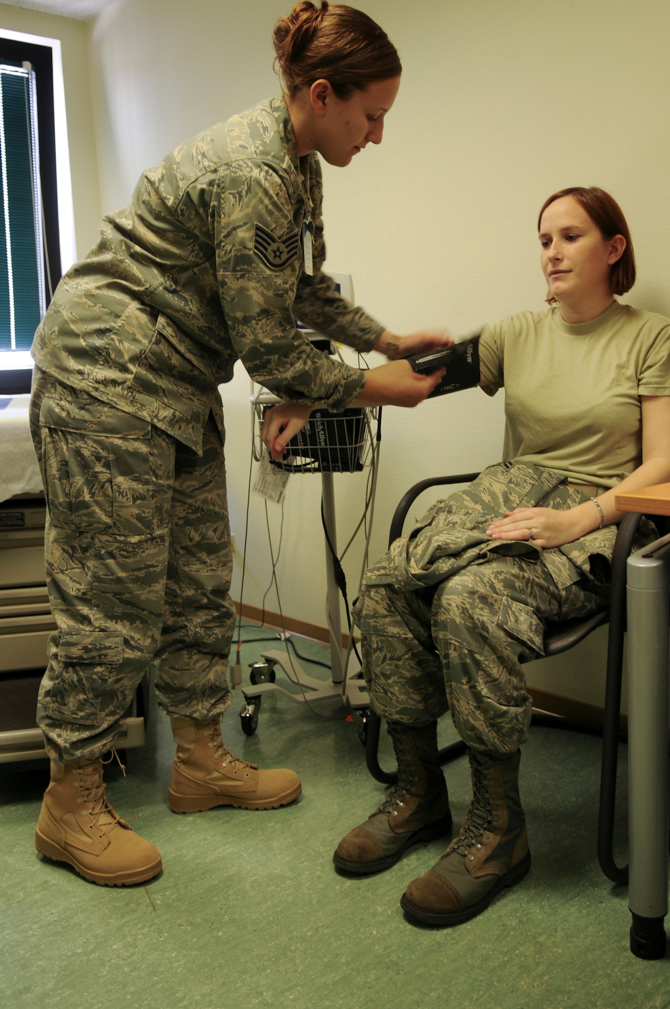 United States Air Force Staff Sgt. Laura Brown, 435th Medical Group, noncommissioned officer in charge of the Physical Health Assessment Office, takes the blood pressure of United States Air Force Airman 1st Class Jillian Chubet, 435th MDG medical technician, May 14, 2009, Ramstein Air Base, Germany. The Family Medicine Clinic has about 70,000 patients they see annually. (U.S. Air Force photo by Airman 1st Class Alexandria Mosness)