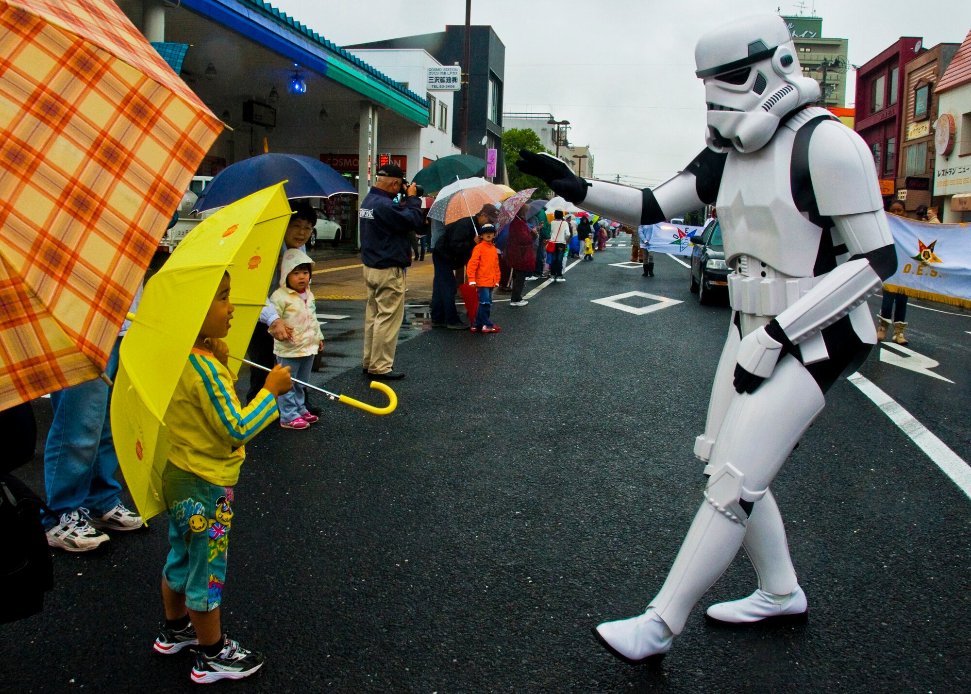 MISAWA AIR BASE, Japan -- A storm trooper waves at a Japanese boy during the American Day parade June 7, 2009. Despite the rain, Japanese and Americans came out to enjoy the parade featuring popular American characters and icons. (U.S. Air Force photo by Staff Sgt. Araceli Alarcon)
