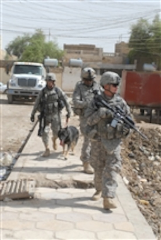 U.S. Army soldiers attached to 4th Battalion, 6th Infantry Regiment, 4th Brigade Combat Team, 1st Armored Division and soldiers attached to the provost marshal’s office with Multi-National Corps - Iraq search for evidence of insurgency in a town in the Maysan province of Iraq on June 2, 2009.  