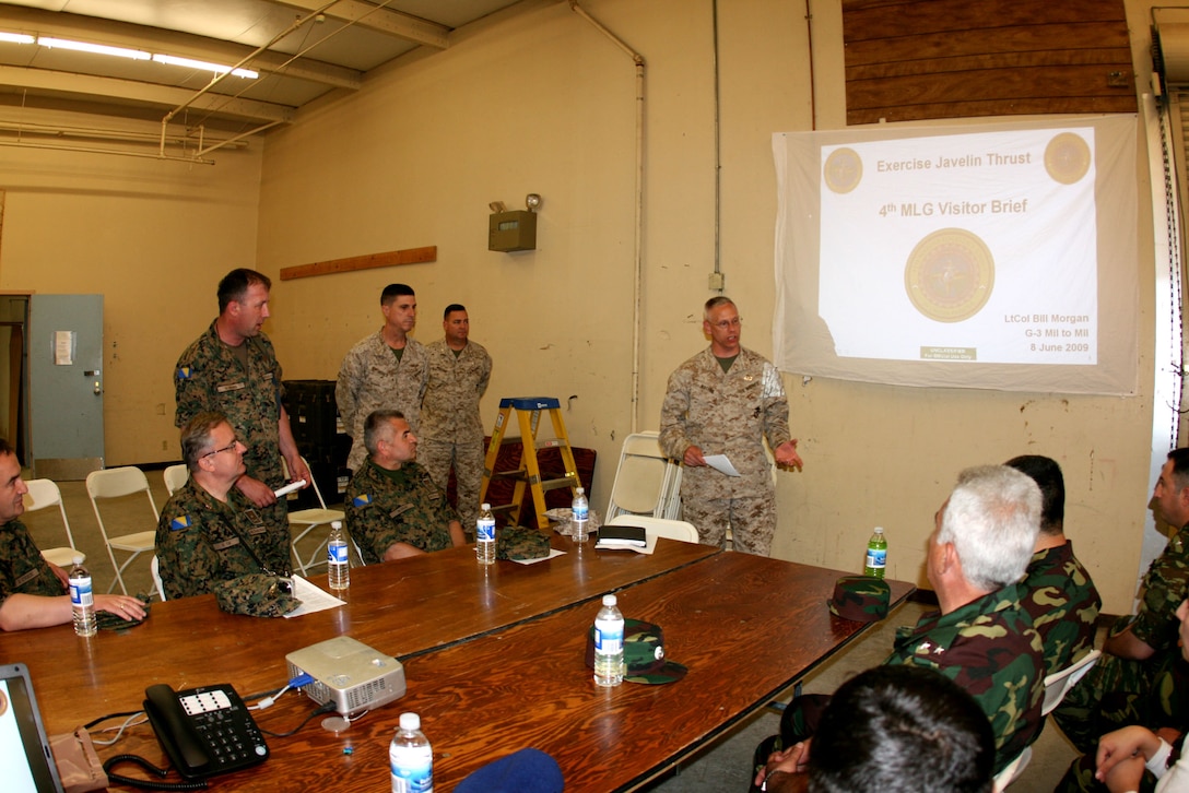 Col. Roger Machut, the deputy commander of 4th Marine Logistics Group, provides an orientation brief to international soldiers from the Bosnia and Herzegovina Armed Forces and the Armed Forces of Armenia in the unit’s command operations center June 8.  The Marines are here to conduct Javelin Thrust 2009, is a Marine Forces Reserve exercise designed to prepare reserve units for their role in deployed Marine Air Ground Task Forces.  Machut has spent 21 of his 27 years in the Marine Corps as a reservist.  An engineer officer and logistician by military occupational specialty, Machut is a civil engineer in his civilian career.