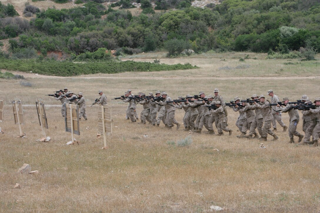 Marines and sailors from 22nd Marine Expeditionary Unit familiarize themselves with the different stages of the combat marksmanship program at Melissatika training area near Volos, Greece June 8, 2009. Elements of the MEU went ashore in Greece for a 12-day training evolution. The 22nd MEU is embarked aboard the ships of the Bataan Amphibious Ready Group and is currently serving as the theater reserve force for U.S. European Command.::r::::n::(Official Marine Corps photo by Cpl. Theodore W. Ritchie)