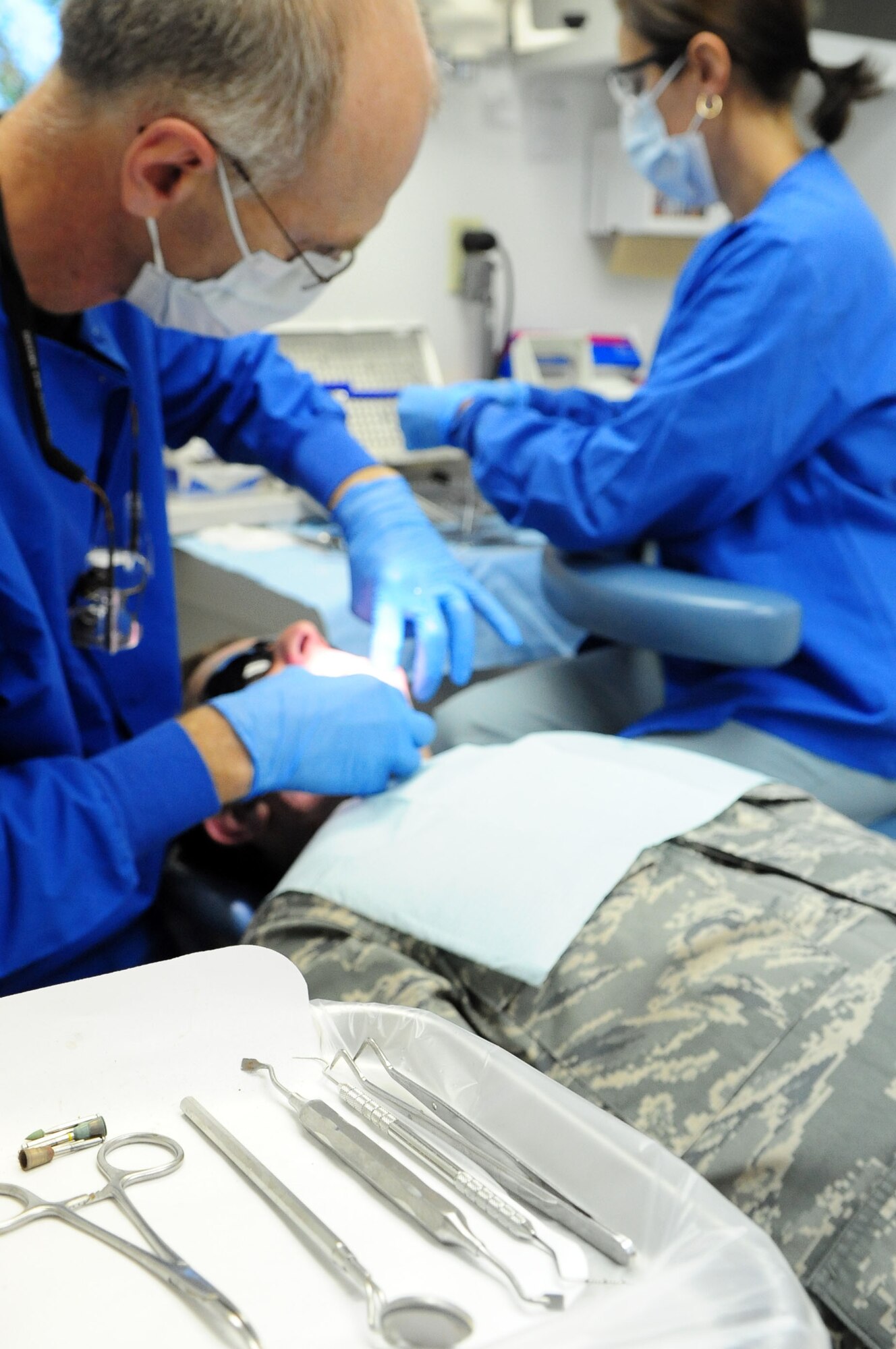 BARKSDALE AIR FORCE BASE, La. -- A resident in the advanced education in general dentistry program performs a routine procedure on a patient at the 2d Dental Squadron clinic, June 5. (U.S Air Force photo by Senior Airman Joanna M. Kresge)