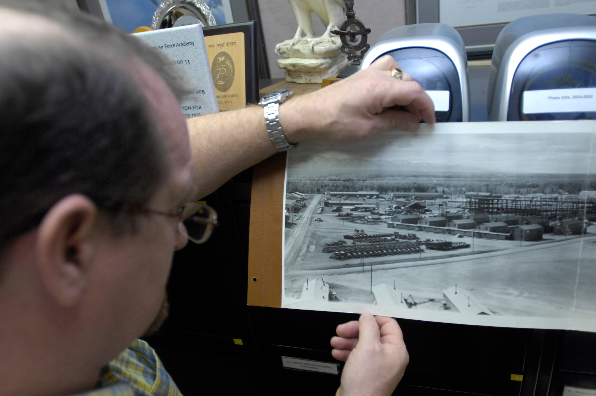 ELMENDORF AIR FORCE BASE, Alaska -- Joe Orr, 3rd Wing History Office, looks at a historical photo on file June 3, 2009. This photo shows what Elmendorf looked like in 1948. At the time, several major buildings were under construction. Orr and his co-workers received the 2009 John R. Burton Award for best history office in the Air Force.(U.S. Air Force photo/Airman 1st Class Christopher Gross)