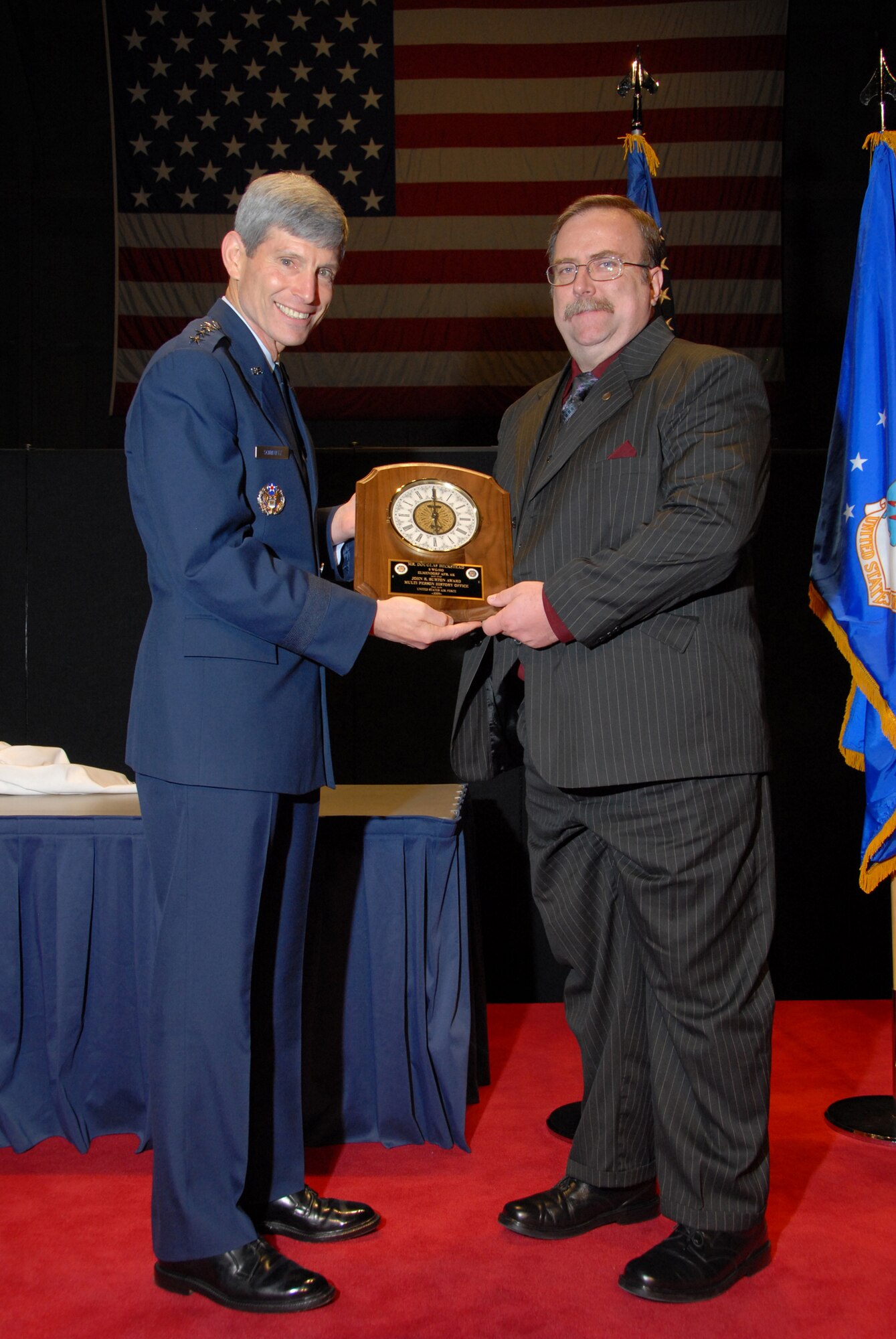 WRIGHT PATTERSON AIR FORCE BASE, Ohio -- Gen. Norton A. Schwartz, Air Force Chief of Staff, presents Doug Beckstead, 3rd Wing historian, the John R. Burton Award here May 13, 2009. The John R. Burton Award is given biennial to the best history office in the Air Force. (Courtesy photo)