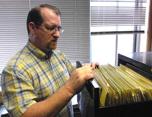 Joe Orr, 3rd Wing History Office, scans through historical documents that date back to 1918, which is around the time when the 3rd Pursuit Group was established. Mr. Orr and his co-workers at Elmendorf Air Fporce Base, Alaska, were given the 2009 John R. Burton Award for being the best history office in the Air Force. (U.S. Air Force photo/Airman 1st Class Christopher Gross) 