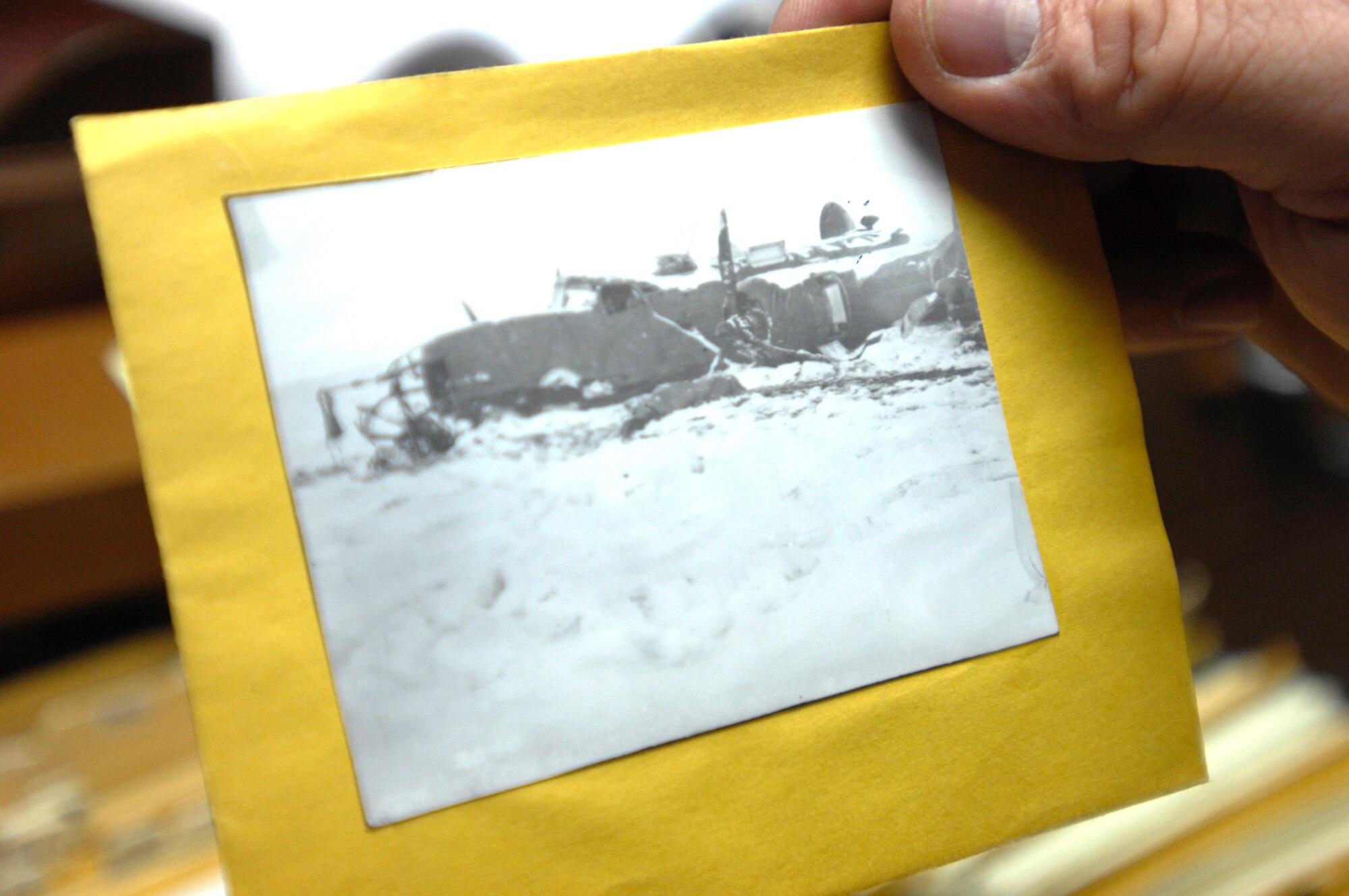ELMENDORF AIR FORCE BASE, Alaska -- Doug Beckstead, 3rd Wing History Office, holds a historical photograph of a B-24D after it took a brutal landing in the Aleutians. Beackstead and his co-workers received the 2009 John R. Burton Award for being the best history office in the Air Force. (U.S. Air Force photo/Airman 1st Class Christopher Gross)