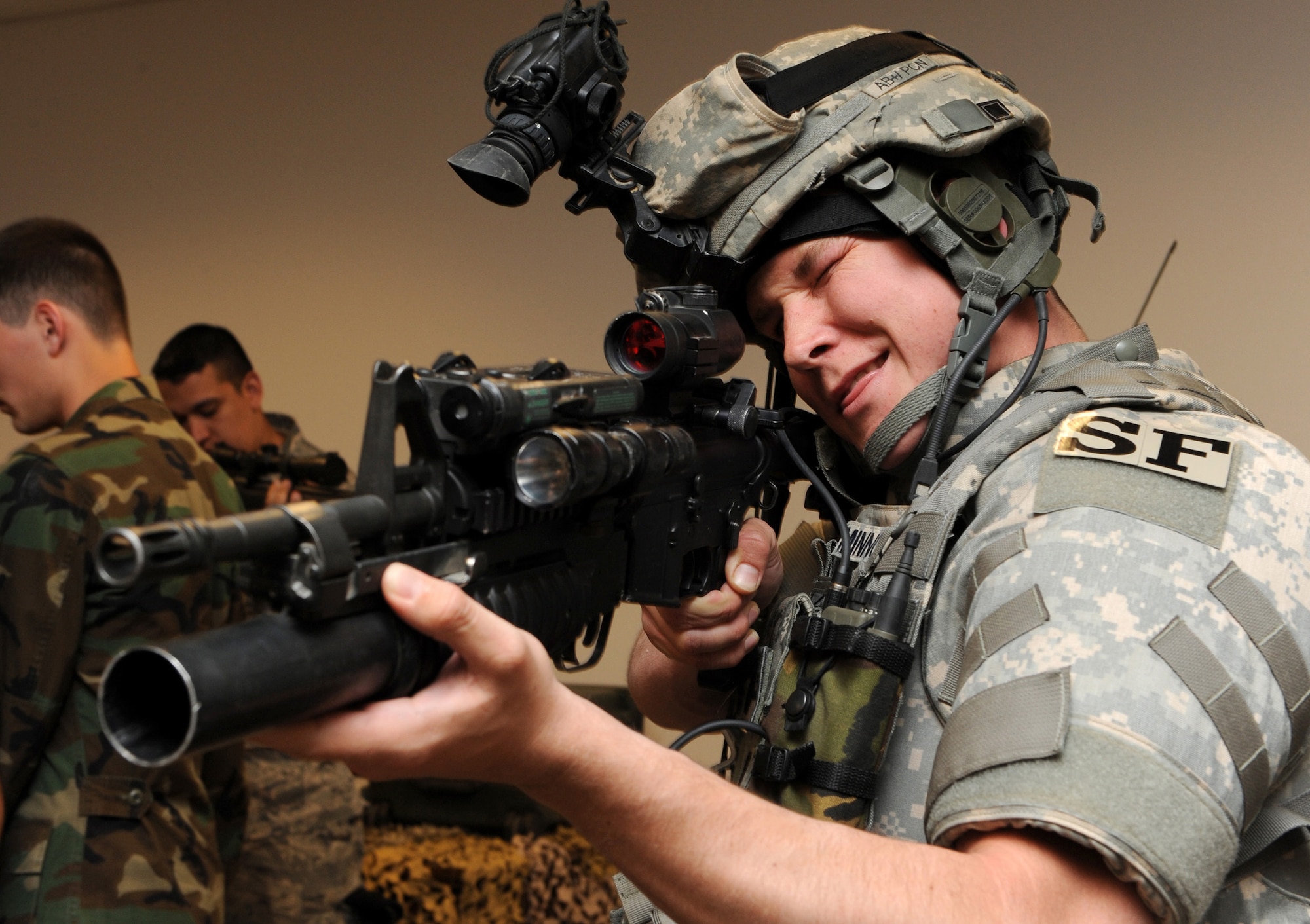 MOUNTAIN HOME AIR FORCE BASE, Idaho -- Caleb Cambell, a sophomore from the University of Oklahoma, tries on protective gear and equipment while aiming a weapon at the 366th Security Forces Squadron June 5. Twenty-six ROTC cadets are at Mountain Home Air Force Base working side-by-side with active-duty Airmen from around the base to gain first-hand knowledge of the Air Force through July 31. (U.S Air Force photo/Airman 1st Class Debbie Lockhart)