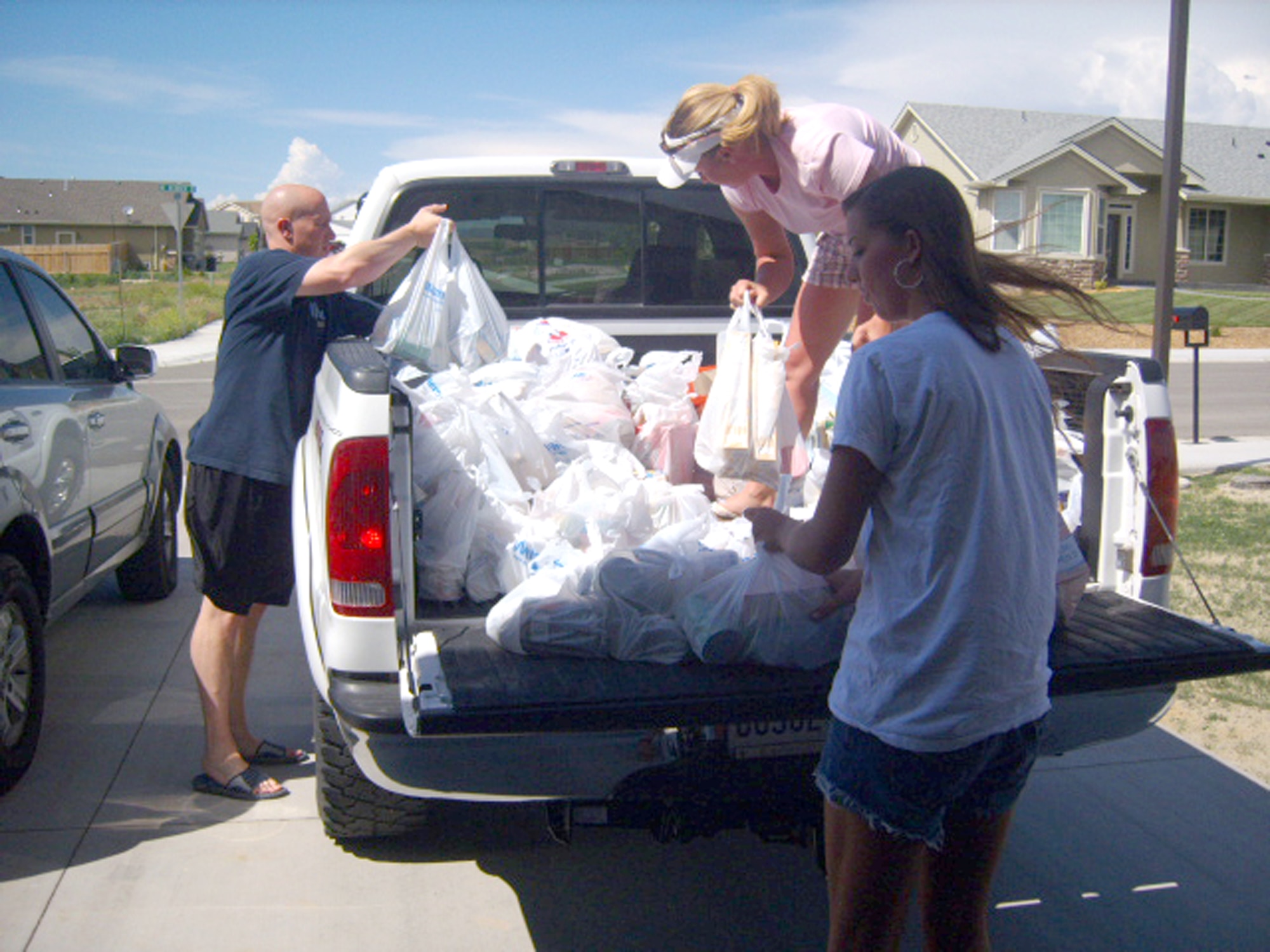 MOUNTAIN HOME AIR FORCE BASE, Idaho – Tech. Sgt. Richard Styles, 366th Operations Support Squadron; Rose Villareal, spouse of Master Sgt. William Villareal 366th Logistics Readiness Squadron; and Airman Victoria Lob, 366th LRS, load food to deliver to the Idaho Food Bank in Boise, Idaho. The 366th Mission Support Group held a food drive from May 18 to 30 with a goal to help out as many people as possible. Several people in the group were collecting donations from their respective squadrons, and the drive ended with an all-day donation drive at the Mountain Home Albertson's and Wal-Mart where 50 volunteers from the group came out and accepted donations from the local community. The food drive raised more than $240 and 1,600 pounds in food for the Idaho Food Bank in Boise, Idaho. (U.S. Air Force photo\ Staff Sgt. Jessica Rosario-Styles)