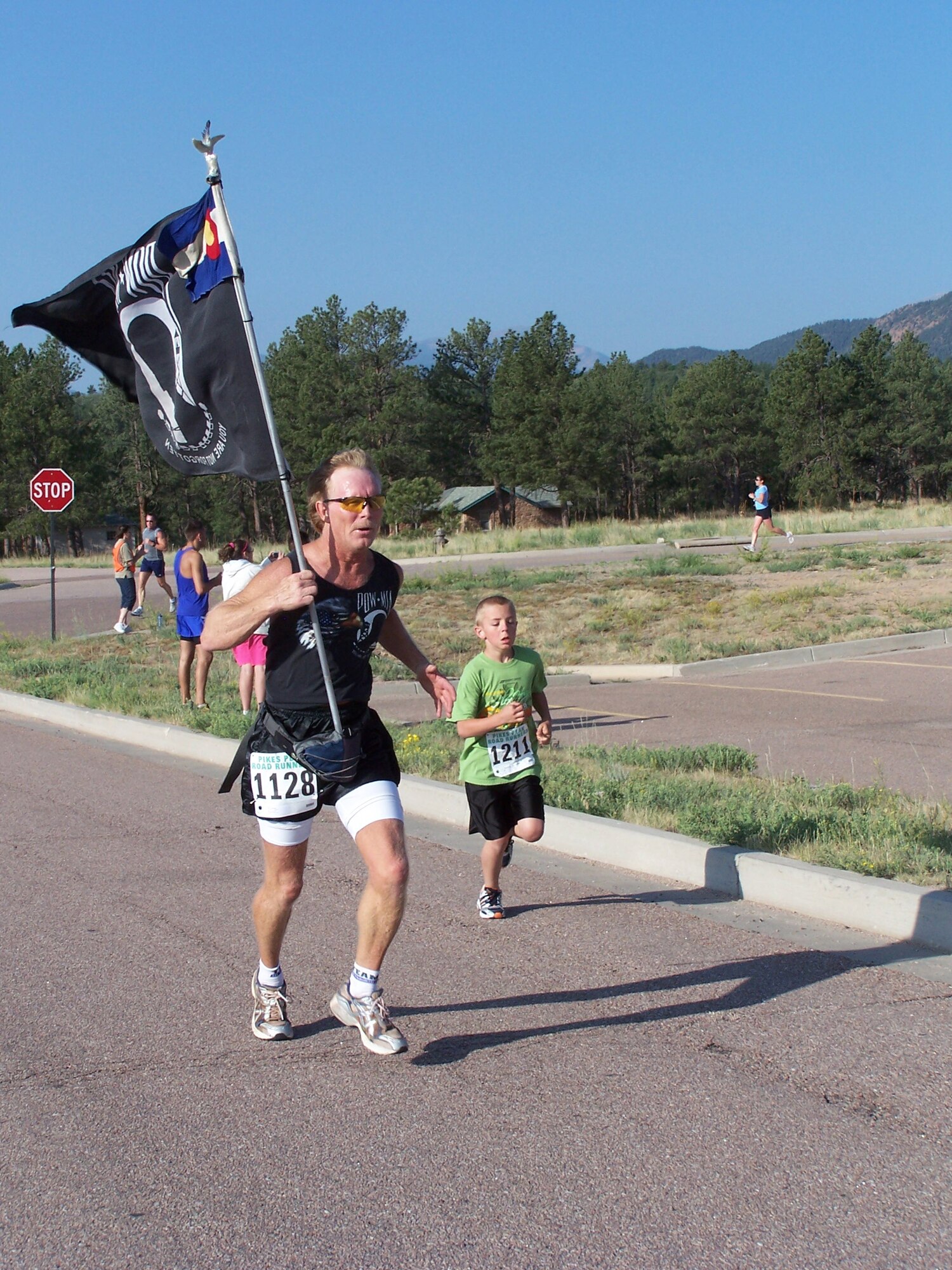 U.S. AIR FORCE ACADEMY, Colo. -- Pikes Peak Road Runner member Mike Olson, ran with the prisoner of war-missing in action flag at last year's Veterans' Home Run 5K run/1K walk. Olson was one of 300 particpants in last year's event. This year's event takes place June 27 at Air Academy High School. (courtesy photo)