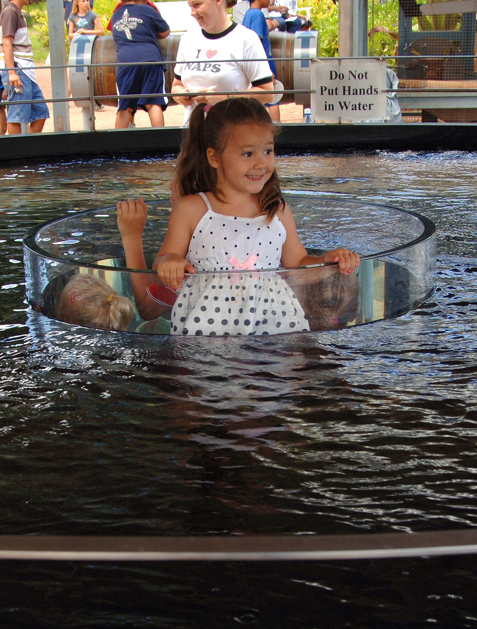 HICKAM AIR FORCE BASE, Hawaii – Trinity Drew, 6, enjoys viewing the large Koi fish tank on display at the Honolulu Zoo during the Military Appreciation Day held June 6.  Trinity was accompanied by her mom, Misty Drew, and her three siblings, while her dad, Staff Sgt. Steven Drew, 15th Airlift Wing noncommissioned officer in charge of chapel readiness, has been deployed for the past two months.  (U.S. Air Force photo by Vanessa Perez)  