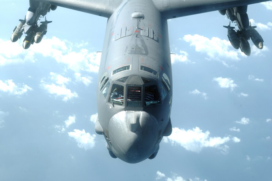 OPERATION ENDURING FREEDOM--The crew of the B-52H Stratofortress, 'Mud Buff', display the American flag following a mid-air refueling stop on November 1st, 2005.  The 96th Expeditionary Bomb Squadron crew carries the flag with them on combat sorties.  The aircraft is armed with a load of Mk. 84, 2000 pound JDAMs (Joint Direct Attack Munition) which is a guided air-to-surface weapon.  The aircraft and the crew are deployed from the 2nd Bomb Wing at Barksdale Air Force Base, Louisana.  (U.S. Air Force photo/Senior Airman Curtis J. Lenz) 