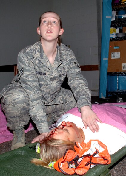 Staff Sgt. Mary Thompson, 49th Medical Operations Squadron, simulates trying to resuscitate Airman Samantha Dennis, 49th Logistics Readiness Center, during a natural disaster exercise at Holloman Air Force Base, N.M., June 4. Victims affected by the simulated tornado were carried to the Community Activity Center as a place of shelter. (U.S. Air Force photo/Airman 1st Class Veronica Stamps)