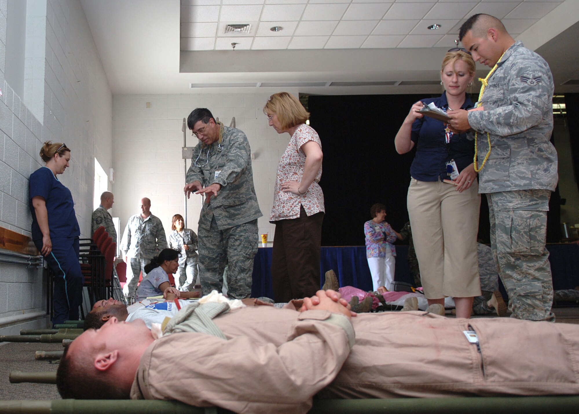 Members of Holloman report to the Community Activitiy Center to recieve medical treatment during the natural disaster exercise at Holloman Air Force Base, N.M., June 4. Personnel from the Installation Control Center and the Emergency Operations Center were activated to conduct necessary actions. (U.S. Air Force photo/Airman 1st Class Veronica Stamps)
