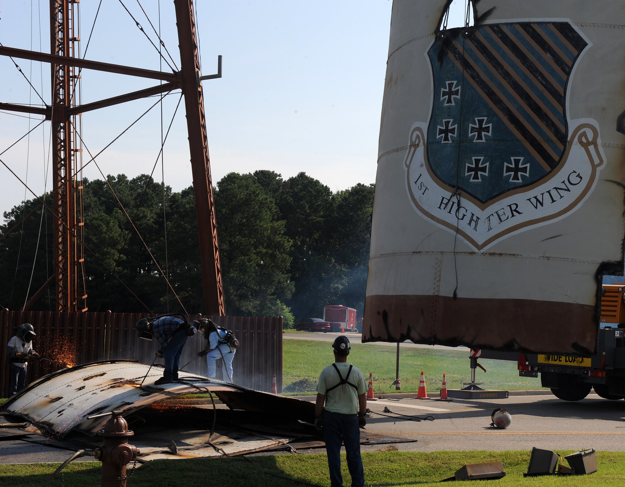 LANGLEY AIR FORCE BASE, Va. -- Contractors tear down the water tower near senior non-commissioned officer housing June 7.  This water tower was built in 1930, but due to deterioration it has not been used since 2004, and is no longer required in the water distribution system. (U.S. Air Force photo/Senior Airman Zachary Wolf)
