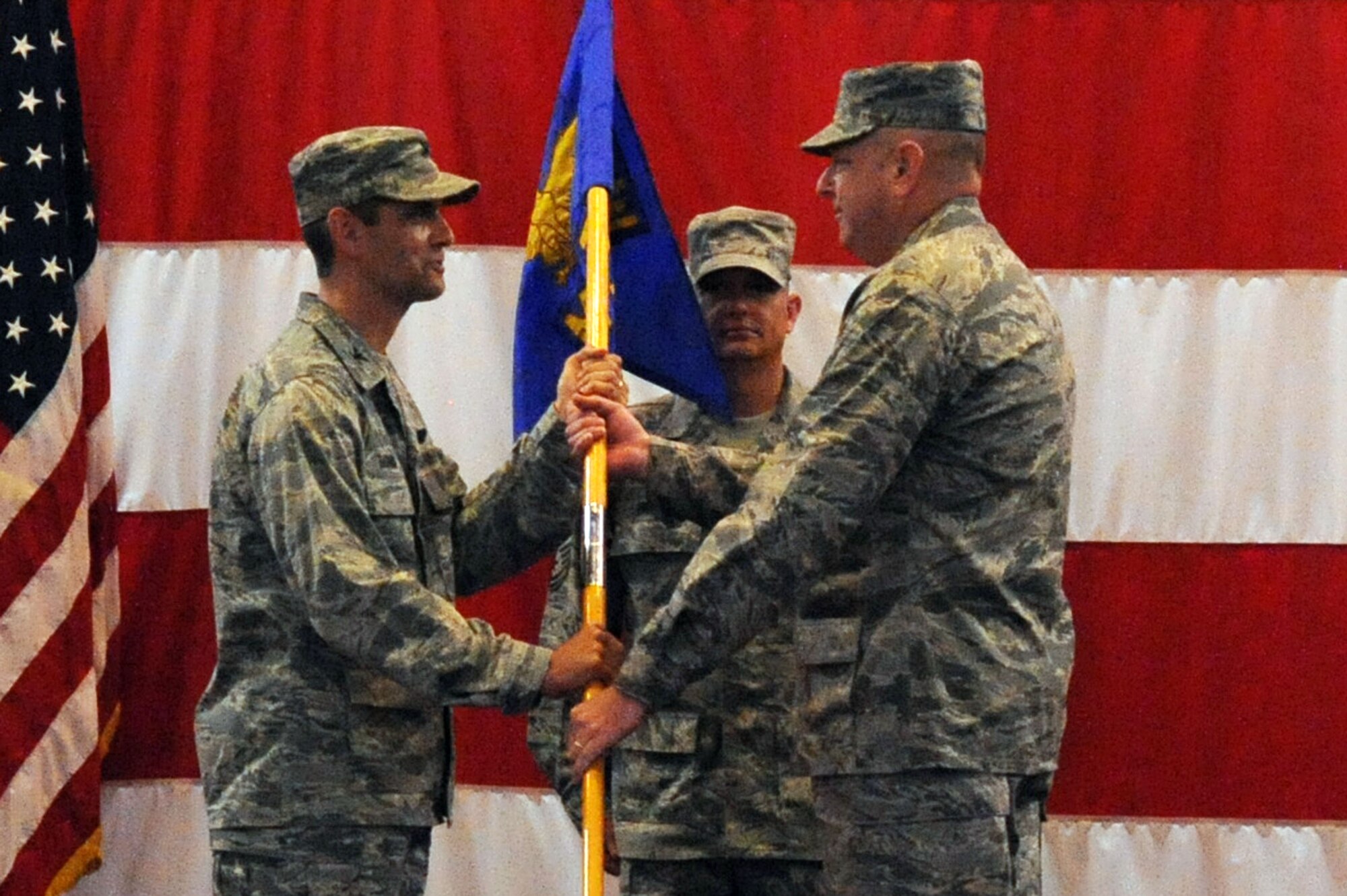 BARKSDALE AIR FORCE BASE, La. -- Col. Charles Johnson recieves the 2d Maintenance Group guideon from Col. Steven Basham, 2d Bomb Wing commander at Hoban Hall, June 2. Colonel Johnson assumes command from Col. Steven Shinkle.(U.S. Air Force photo by Senior Airman La’Shanette Garrett)