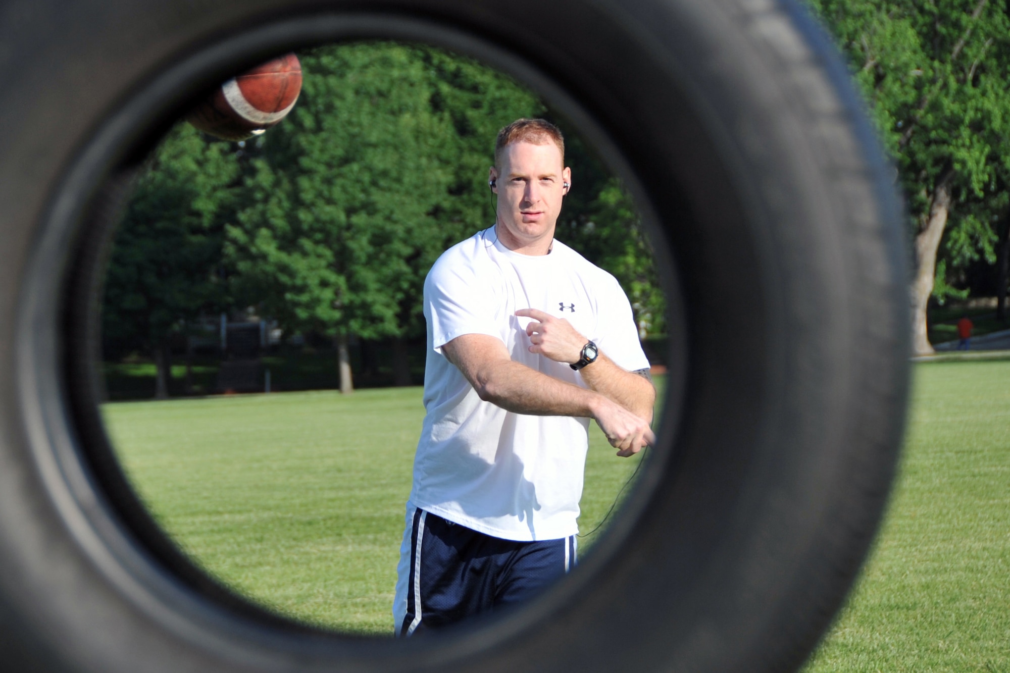 OFFUTT AIR FORCE BASE, Neb. -- 1st Lt. Anthony Purdy, 343rd Reconnisance Squadron, tries his luck at the football toss for the Wing Sports Day at the parade grounds June 5. All base agencies competed in activities including tug-of-war, 110-yard dash and ultimate frisbee. Trophies were presented to the top 3 points gaining units from the combined events during the Offutt Appreciation Day picnic at the Base Lake later that day. 
U. S. Air Force photo by Jeff W. Gates