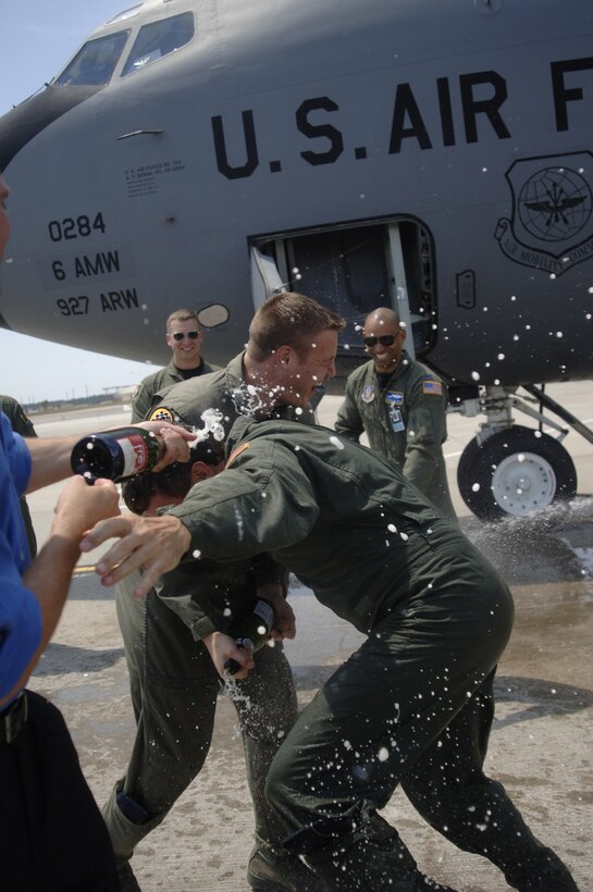 Lt. Col. Michael Mansfield, 63rd Air Refueling Squadron commander, gets the traditional spray down during his final flight as a KC-135 pilot. He spent his entire career as a Stratotanker pilot, from 1982 to 2009. He retired in May. (U.S. Air Force photo/Tech Sgt. Dennis Hauser)