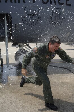 Lt. Col. Michael Mansfield, 63rd Air Refueling Squadron commander, gets the traditional spray down during his final flight as a KC-135 pilot. Colonel Manfeidl spent his entire Air Force career as a Stratotanker pilot, flying from 1982 to 2009. He retired in May. (U.S. Air Force photo/Tech Sgt. Dennis Hauser)