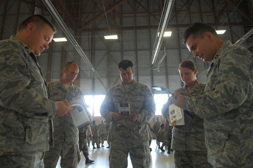 SHAW AIR FORCE BASE, S.C. --  Capt. Victor Menagarcia uses his Airman's Manual to quiz Lt. Col. Brian Wilkey, Senior Airmen Chris Lowe and Gary Anderson and 1st Lt. Lindsey Phillabaum on Self Aid Buddy Care at the Ability to Survive and Operate Rodeo June 5, 2009. Airmen are required to carry their Airman's Manual during the Operational Readiness Inspection. (U.S. Air Force photo/2nd Lt. Emily Chilson)