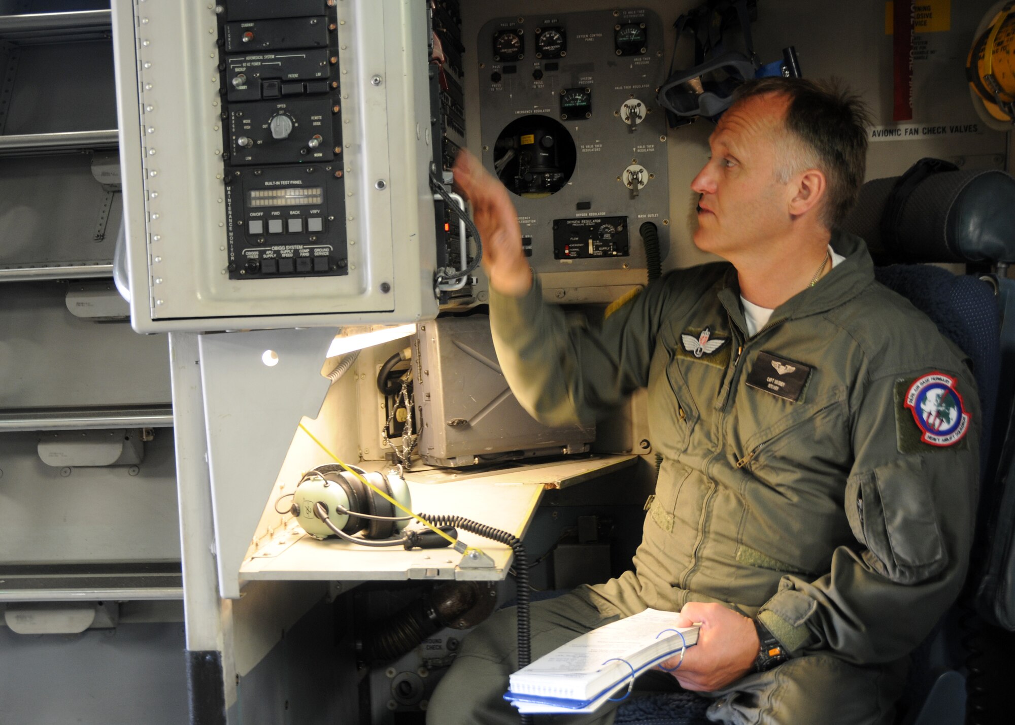 ALTUS AIR FORCE BASE, Okla.–Capt. Havard Brorby sits in the loadmaster seat on a C-17 Globemaster III and performs the pre-flight inspection checklist. The Swedish captain is training with Altus loadmasters for his new role as Chief Loadmaster for the Heavy Airlift Wing in Papa, Hungary.   (U.S. Air Force photo/Senior Airman Jennifer L. Flores)