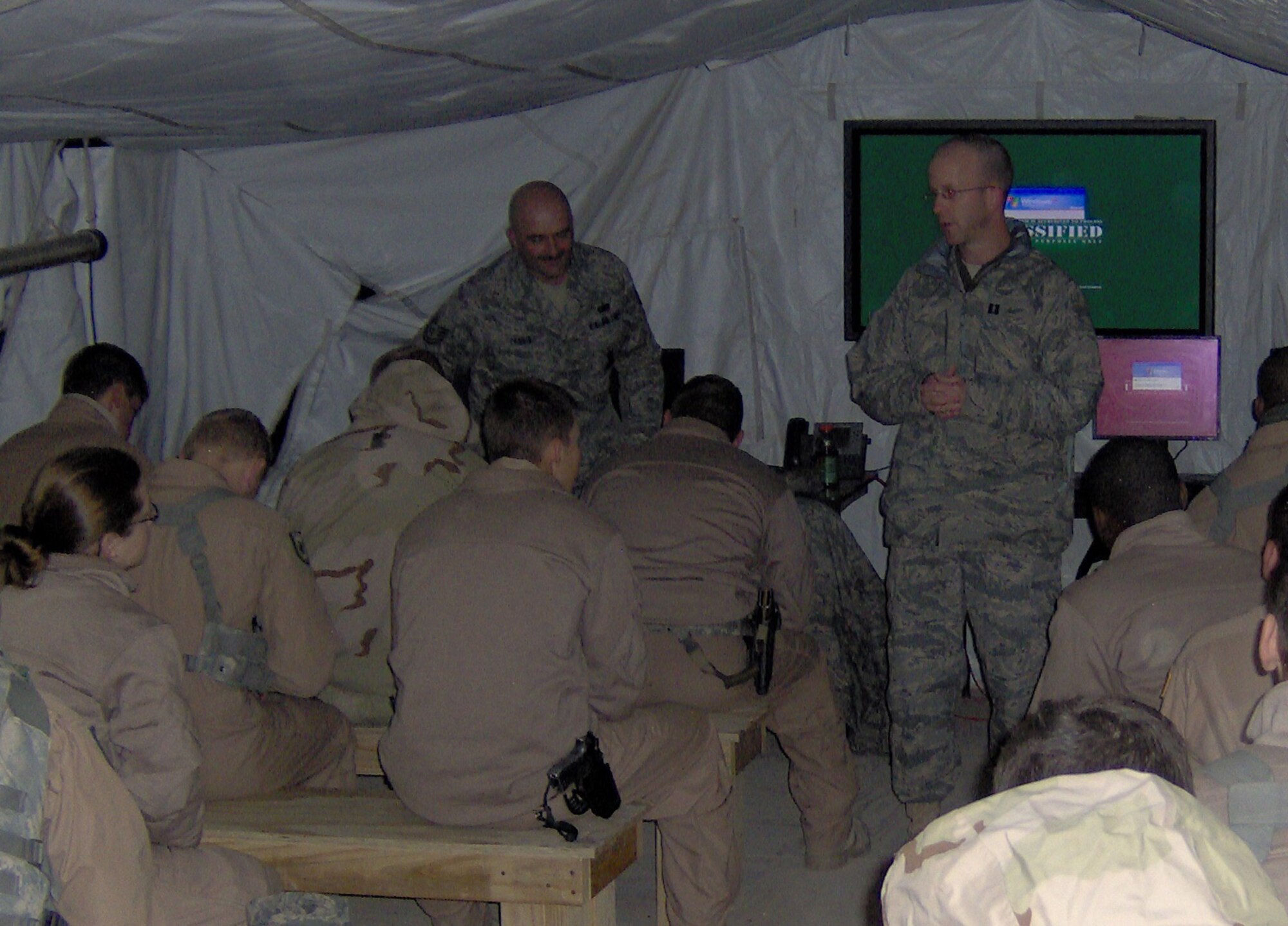 CAMP BUCCA, Iraq -- Chaplain (Capt.) Rolf Holmquist, 887th Expeditionary Secruity Forces Squadron chaplain, speaks to 887th ESFS members during a guardmount before a mission. Chaplain Holmquist practices a "ministry of presence" and believes the best way to relate to the Airmen in his care is to "walk in their shoes." (U.S. Air Force photo by Staff Sgt. Jahn Espino)