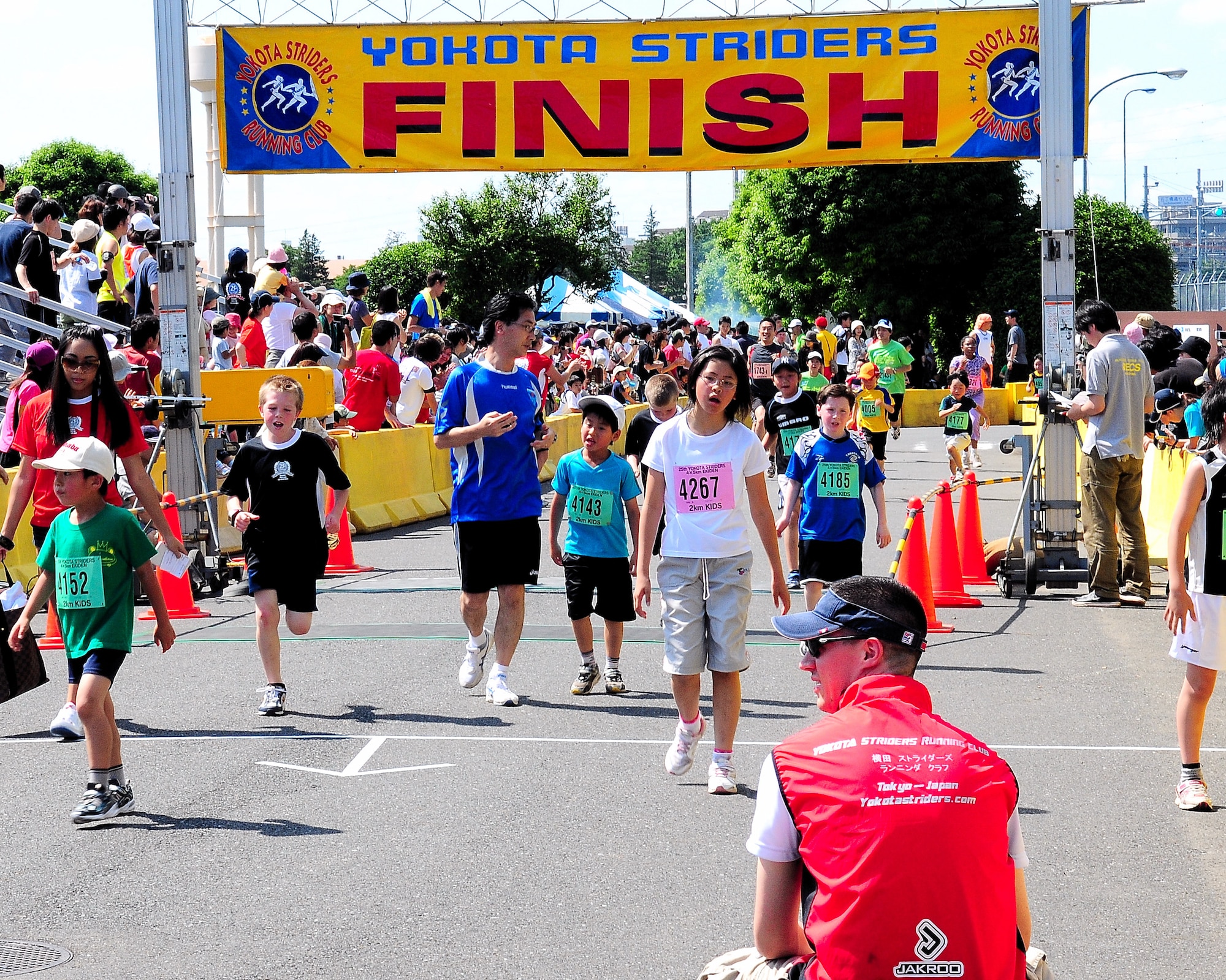 YOKOTA AIR BASE, Japan – Children cross the finish line after the 2K race during the 25th Annual Yokota Striders Ekiden, June 7. The 2K kids race was one of three held that day. More than 9,800 people attended the event this year. (Air Force photo/Airman 1st Class Michael Dillon)
