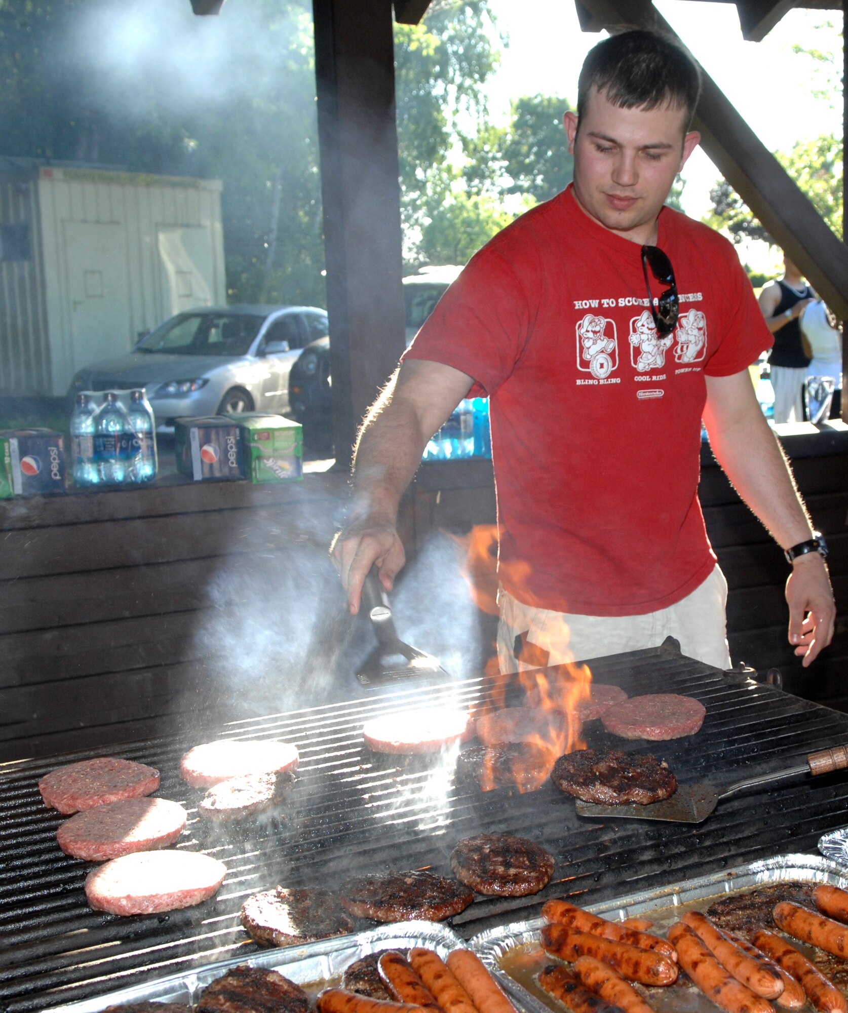 SPANGDAHLEM AIR BASE, GERMANY – First Lieutenant Eric Beebe, 52nd Logistics Readiness Squadron, grills burgers for the 52nd LRS Amazing Race participants May 29, 2009.  The 52nd LRS company grade officers organized a barbeque at the end of the race, modeled after the popular TV show, to give the Airmen of the 52nd LRS a mentally- and physically-challenging, non-alcoholic activity to enjoy.  (U.S. Air Force photo by Master Sgt. Bill Gomez) 