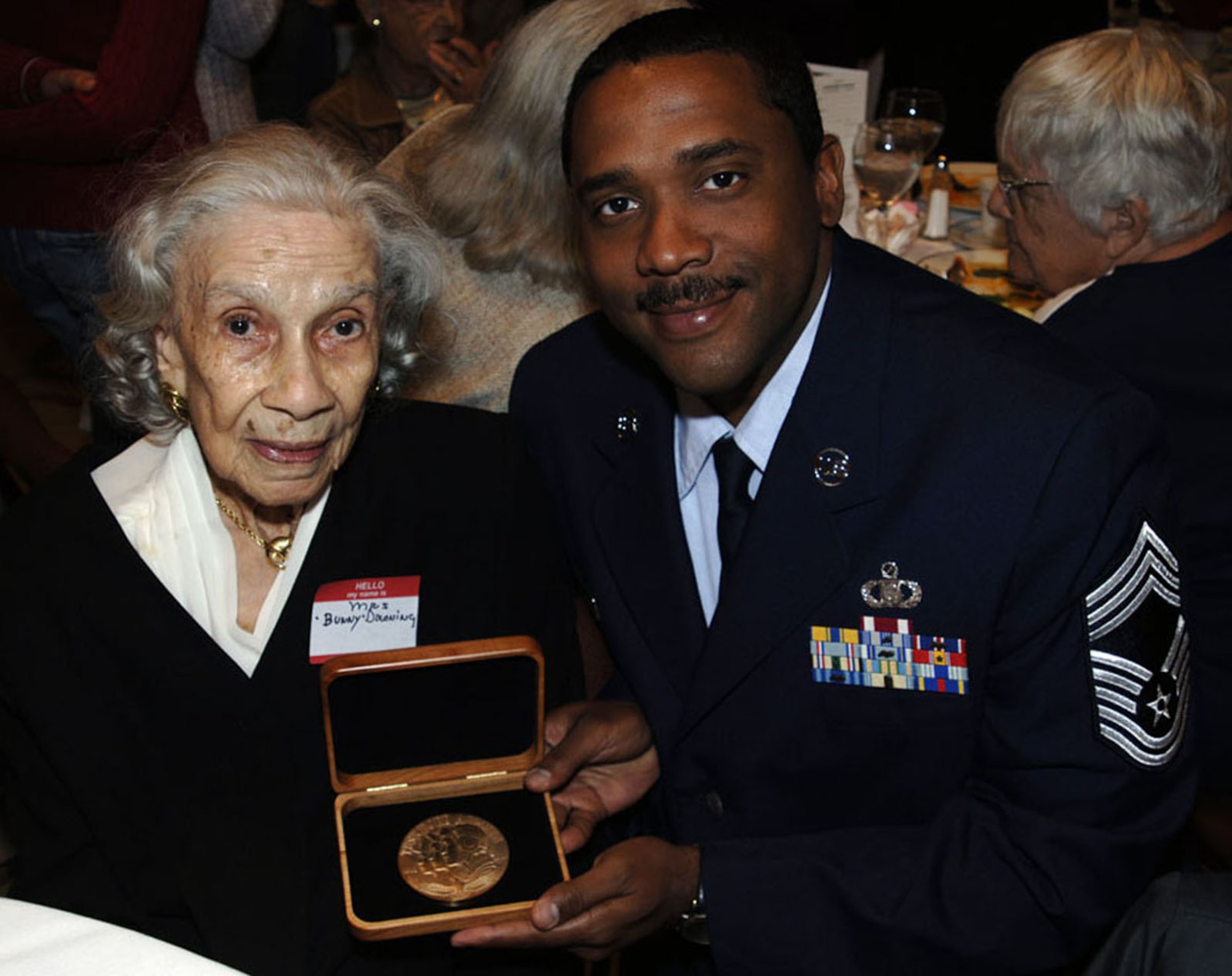 Chief Master Sgt. John Langston's late grandfather, legendary jazz great Al Downing, was awarded the Congressional Gold Medal at a luncheon on April 7, 2009. Mr. Downing's wife, Edna "Bunny" Downing, Chief Langston's grandmother, recieved the award on his behalf.  (U.S. Air Force photo/Tech Sgt. Denise Hauser)