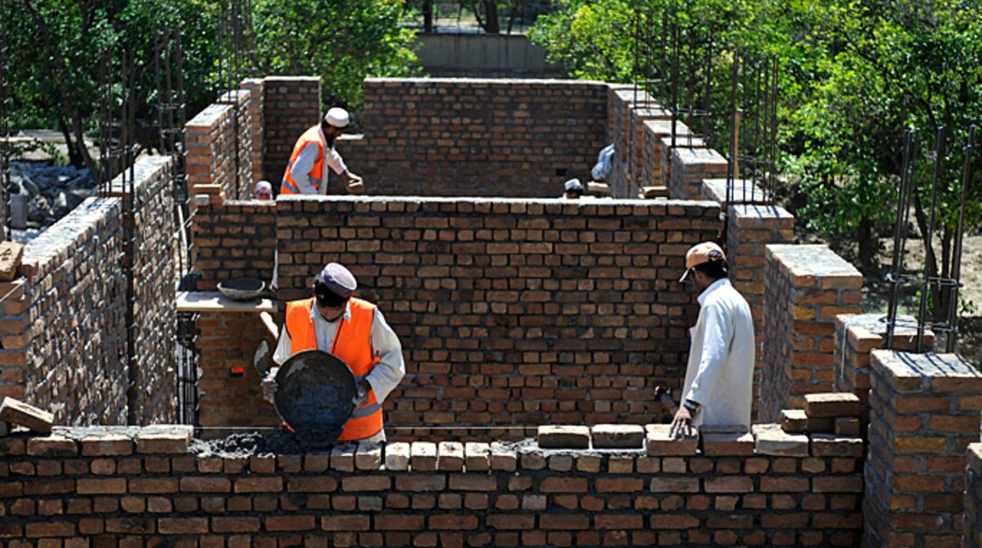 Afghan contractors spread mortar at a development site in the Nangarhar province, Afghanistan, May 30, 2009. The development is being monitored by a Provincial Reconstruction Team, out of Forward Operating Base Finley-Shields in the Nangarhar province.