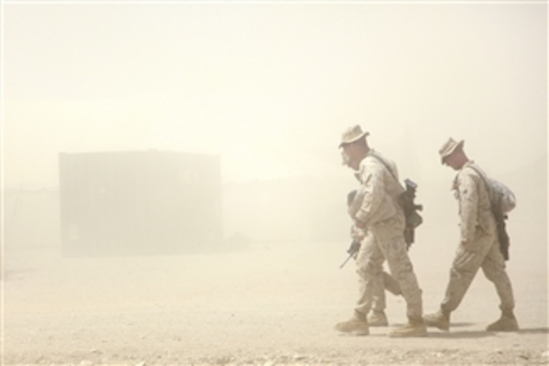 U.S. Marines with Charlie Company, 1st Battalion, 5th Marine Regiment walk through a sand storm to do laundry at life support area 4, Camp Leatherneck, Afghanistan, on June 4, 2009.  The Marines are deployed to Afghanistan in support of Operation Enduring Freedom.  