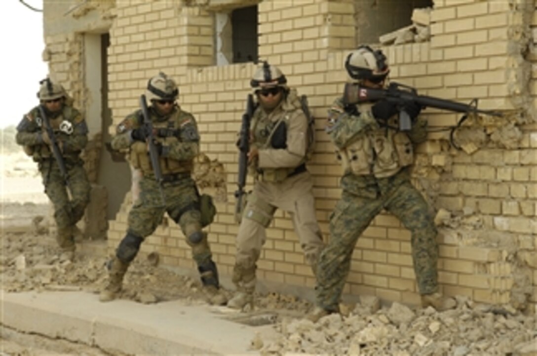 Iraqi soldiers prepare to enter a house during a joint training exercise near Bahbahani, Iraq, on June 6, 2009.  The exercise is being conducted with U.S. Army soldiers from Echo Company, 5th Cavalry Regiment, 172nd Infantry Brigade.  