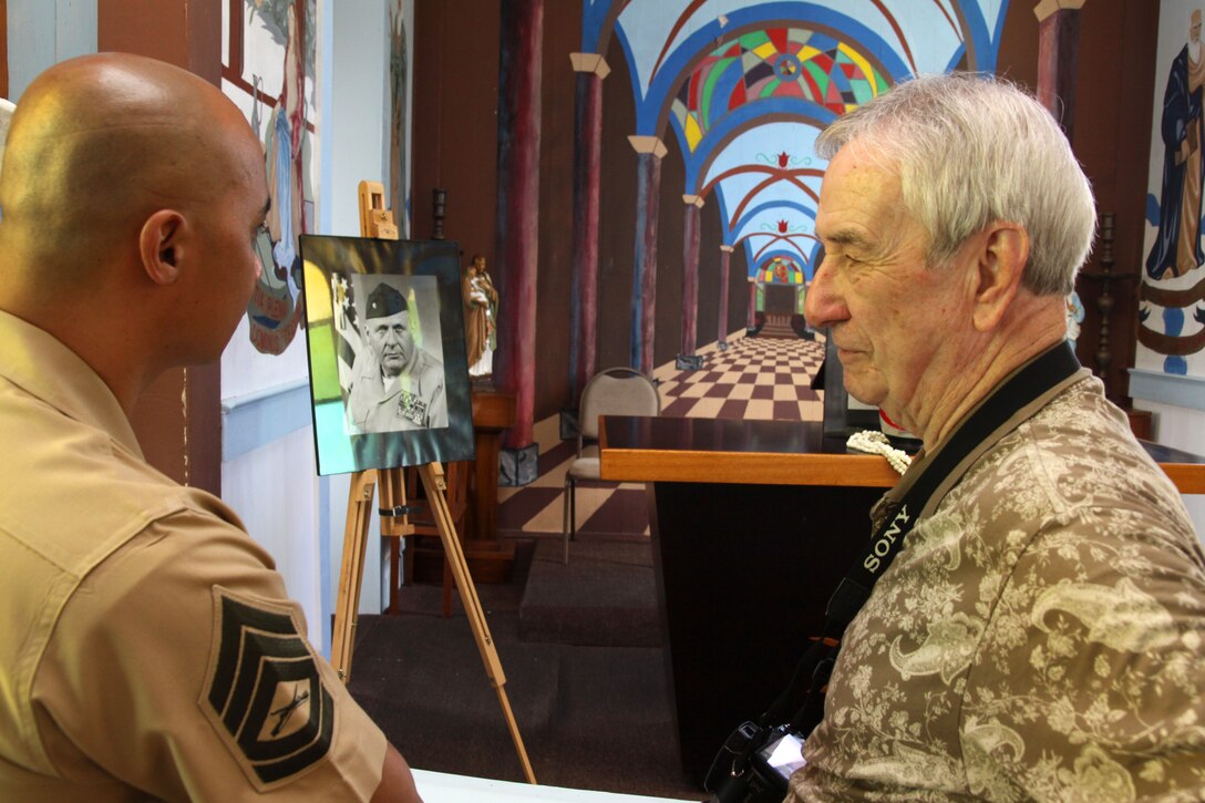 (From left to right) Gunnery Sgt. Arsenio Cortez and retired Capt. Jack Paxton pay their respects to Retired Lt. Col. Jack Lewis, June 11, at the Star of the Sea Church. Lewis died May 24 in his home after battling lung cancer. Lewis is survived by his wife Stephanie Lewis, five children and eight grandchildren.::r::::n::Cortez is the Marine Corps Base Hawaii Public Affairs chief. Paxton is the U.S. Marine Corps Combat Correspondent’s Association executive director.  ::r::::n::