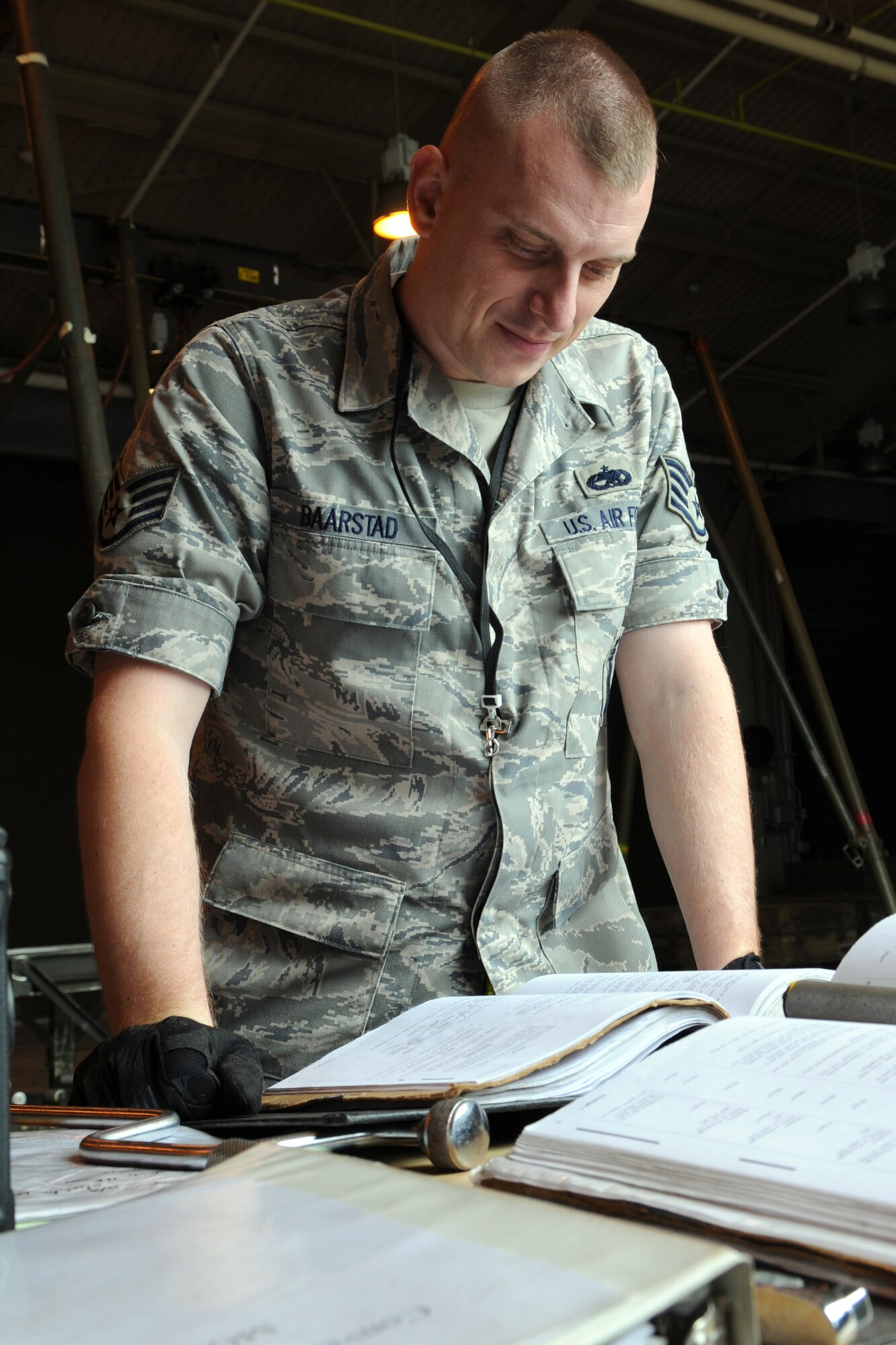 MISAWA AIR BASE, Japan -- Staff Sgt. Robert Baarstad, 35th Maintenance Squadron munitions flight crew chief, reads a technical order prior to building a munition June 9, 2009. Sergeant Baarstad, a native of Boise, Idaho, led a three-man crew in building two GBU-38s for training purposes. (U.S. Air Force photo by Staff Sgt. Rachel Martinez)