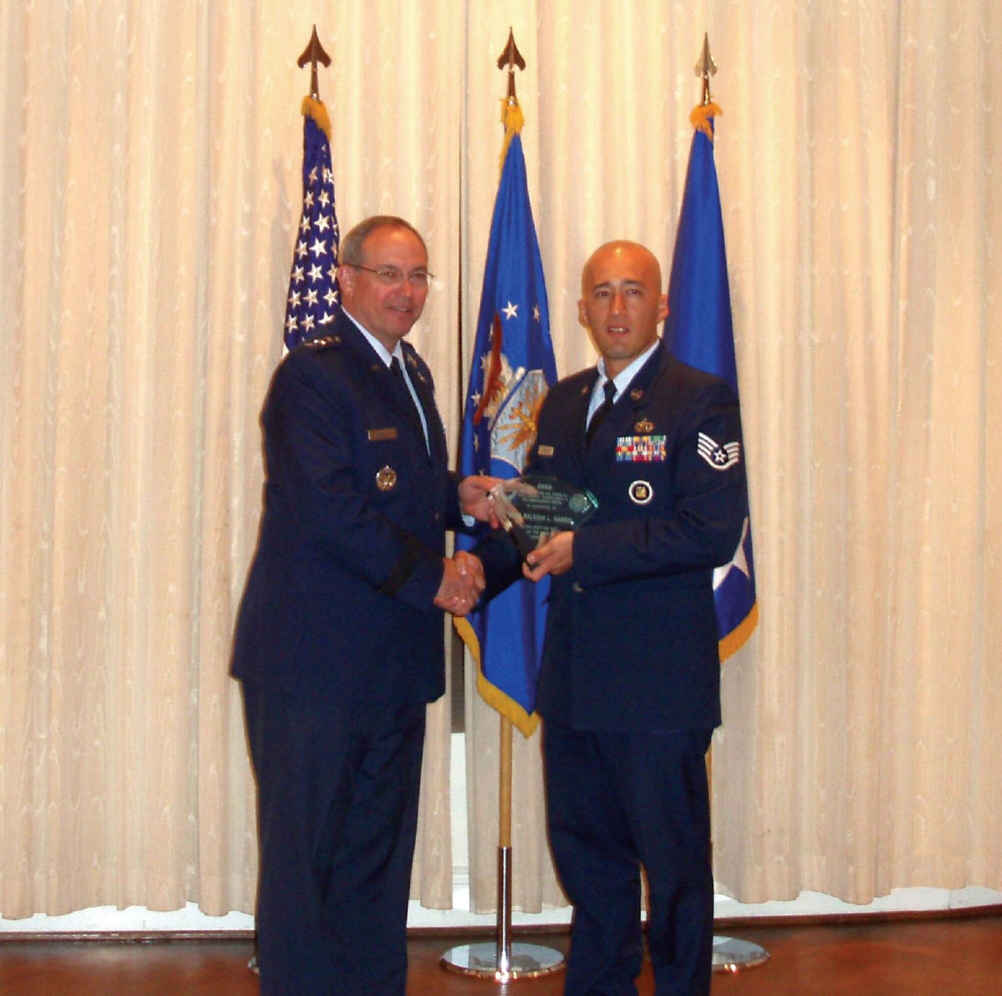 WASHINGTON, D.D. -- Staff Sgt. Raleigh Harris receives the Outstanding Intelligence NCO of the Year from Lt. Gen. David Deptula, Deputy Chief of Staff for ISR at Headquarters Air Force, Pentagon. (Courtesy photo)
