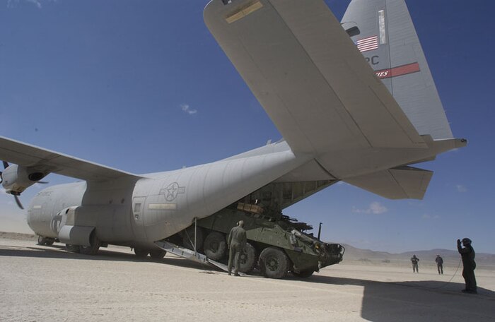 A Stryker Mortar Carrier exits the tail of a C-130 aircraft after landing at Bicycle Lake Army Airfield at the National Training Center, Fort Irwin, Calif. Throughout the next two months Air  Mobility Command plans to move 300-plus vehicles and support equipment totaling nearly 9,500 tons into Afghanistan. (U.S. Army photo/Sgt. 1st Class Gary Ogilvie)