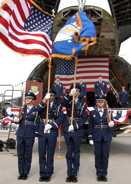Members of the Travis Honor Guard present the colors prior to the singing of the national anthem during the 60th Operation Support Group change of command.  The ceremony took place on the flightline of Travis Air Force Base, California, June 1st 2009. (U.S. Air Force photo by Civ/Nan Wylie)