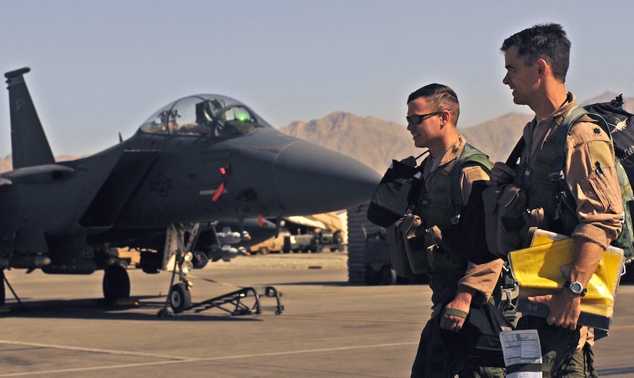 Lt. Col. Christopher Didier (right), an F-15E pilot with the 336th Expeditionary Fighter Squadron at Bagram Airfield, Afghanistan, and Capt. Thomas Veilleuxwalk, an F-15E weapons system operator, leave the flightline after completing a close-air-support mission June 9. In May, aircrews from the 336th EFS and the 74th EFS, who fly A-10 Thunderbolt IIs, together logged a total of more than 5,000 combat flight hours over Afghanistan. The aircraft assigned here provide close-air support and airborne intelligence, surveillance and reconnaissance for American and coalition ground troops. (Air Force/Staff Sgt. Jason Lake)