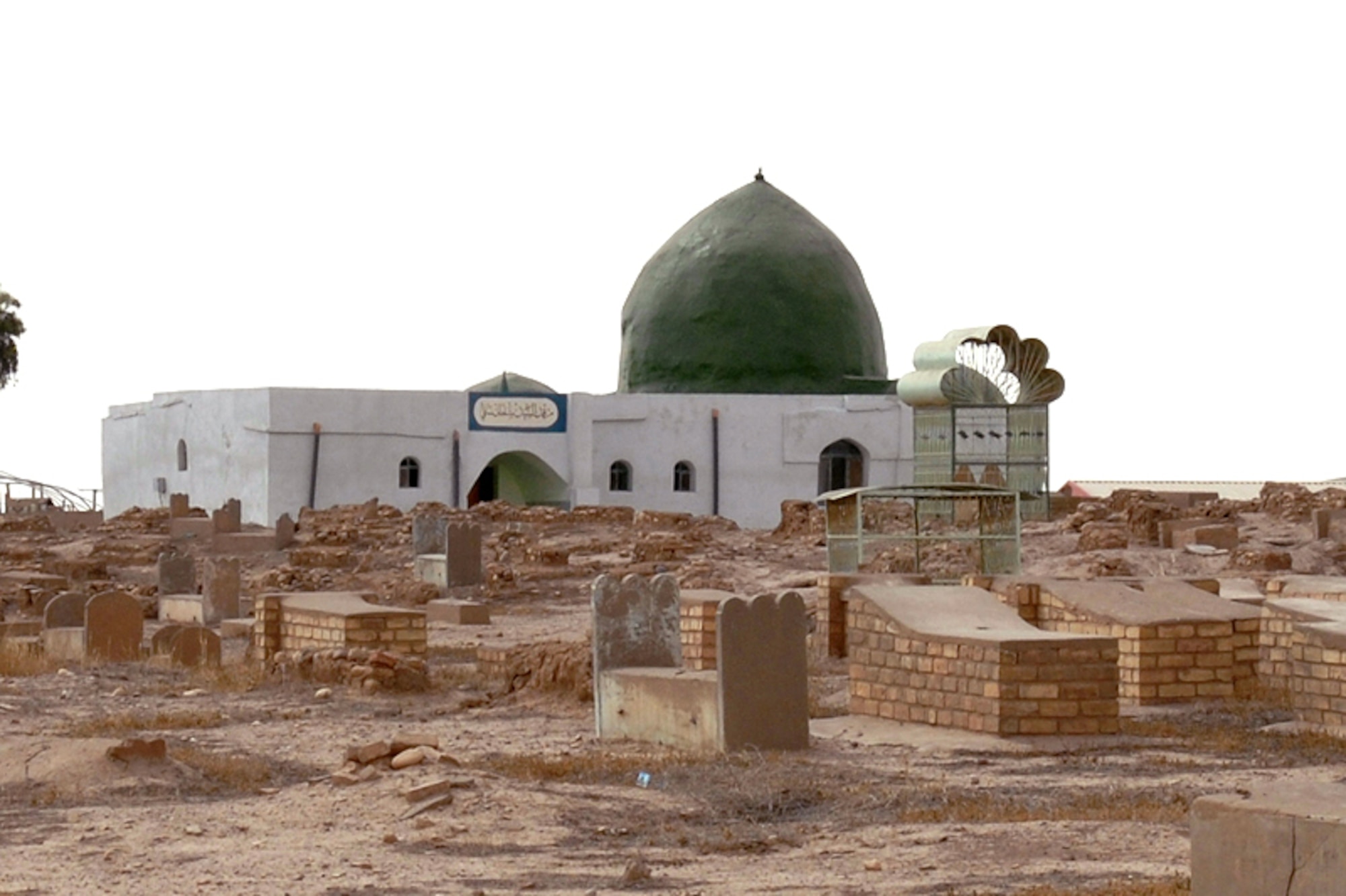 The newly restored Sultan Saqi Shrine sits at the far end of an on-base cemetery. A coalition team collaborated to restore the shrine prior to a May 27 visit by local families of buried relatives, and Iraqi civic and religious leaders. The shrine and cemetery grounds are believed to be more than 400 years old. (U.S. Air Force photo/Staff Sgt. Eunique Stevens)