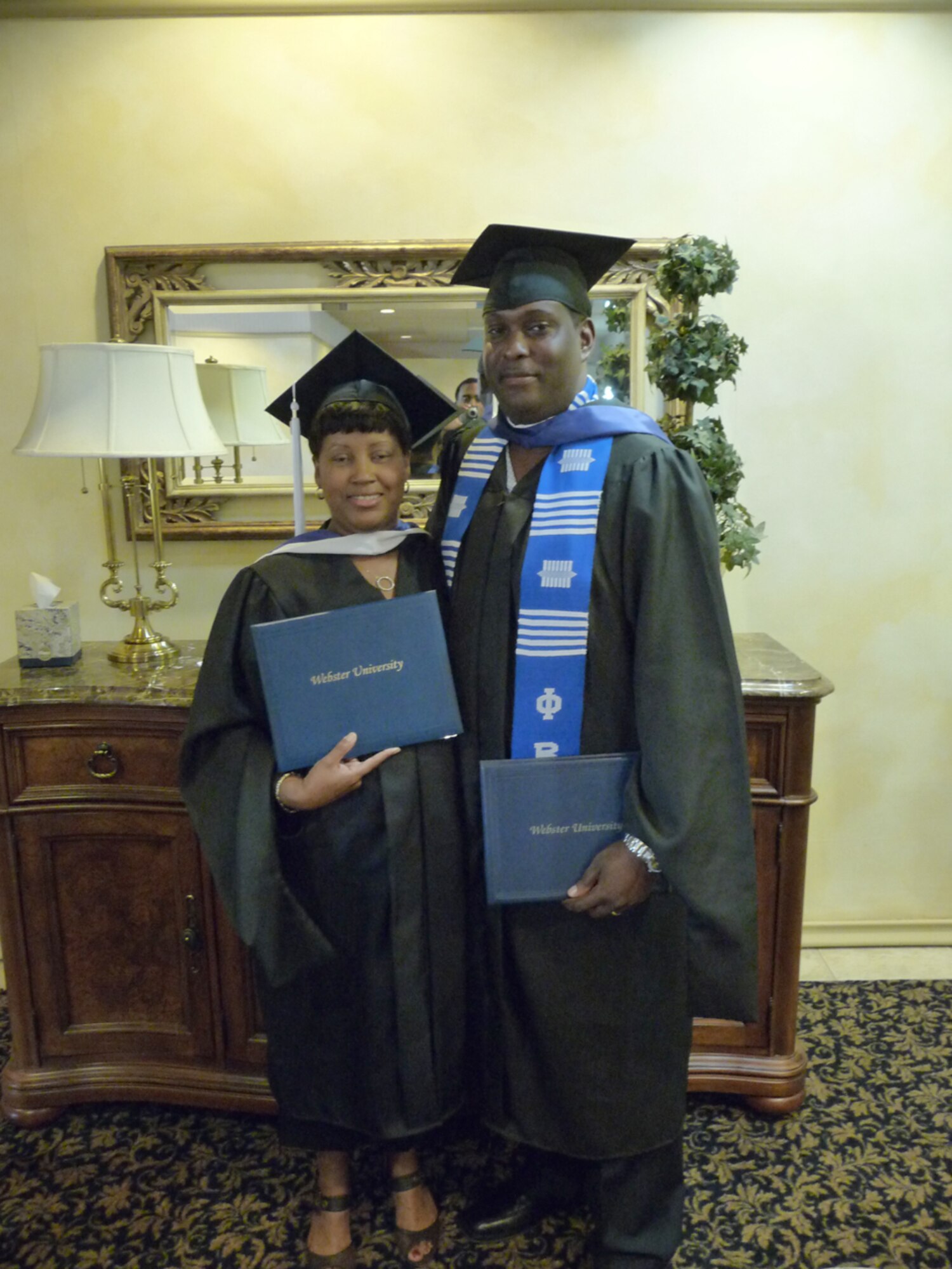 Natasha Green (left), 95th Force Support Squadron Human Resource specialist, and her husband, Kenneth Green, 95th Communications Group planning and implementation computer scientist, graduated during a ceremony at Club Muroc June 6. Mrs. Green graduated with a Master of Arts in Management and Leadership at Webster University-Edwards campus. Mrs. Green was diagnosed with early stage of breast cancer during her first year in graduate school and is now cancer-free. (Courtesy photo)