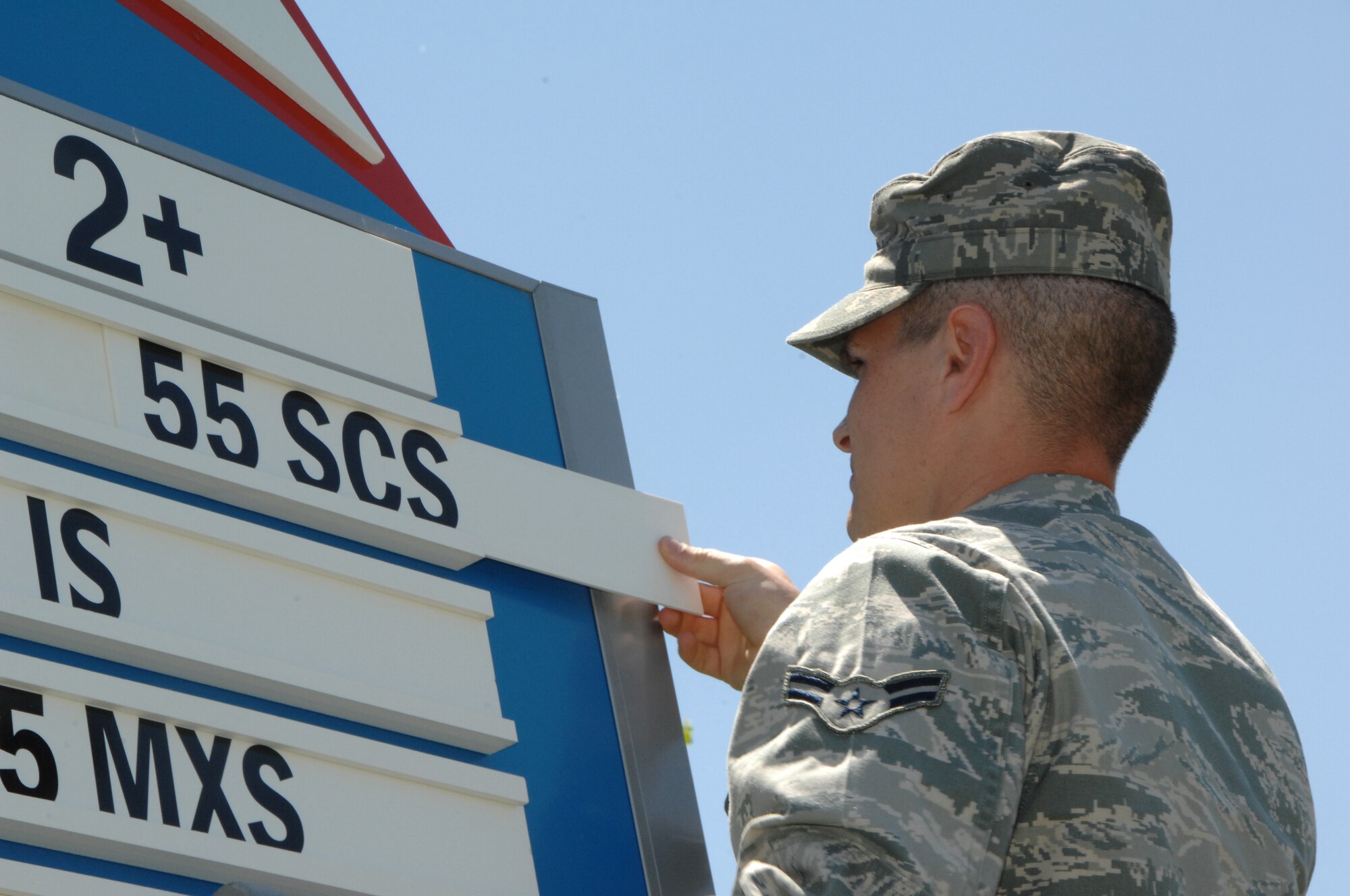 OFFUTT AIR FORCE BASE, Neb. -- Airman 1st Class Cameron D. Smith, a software quality assurance analyst with the 55th Strategic Communications Squadron,  removes the unit's placard from the two-year mark of the DUI awareness board inside the Kenney Gate June 4. The 55th SCS is one of seven units who've been DUI free for three years or more. U.S. Air Force Photo by Mr. D.P. Heard