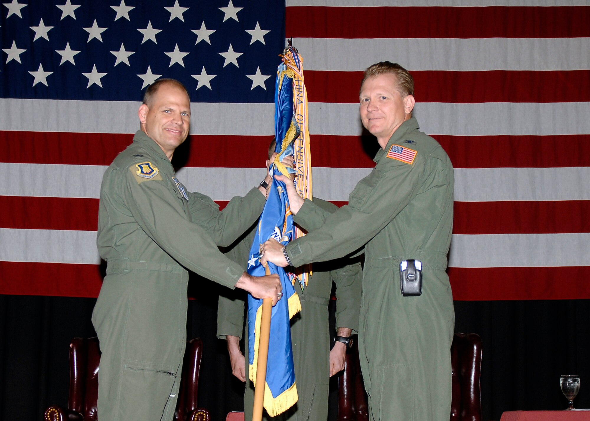 MCCONNELL AIR FORCE BASE, Kan. -- Col. Bart Weiss, 22nd Operations Group commander, hands off the guidon to Col. James C. Vechery, 22nd Air Refueling Wing commander, during the Operations Group change of command ceremony at the Robert J. Dole Community Center ballroom, June 5. Colonel Weiss passes the guidon to symbolize his relinquishing of his command. (Photo by Senior Airman Anthony Mejia)