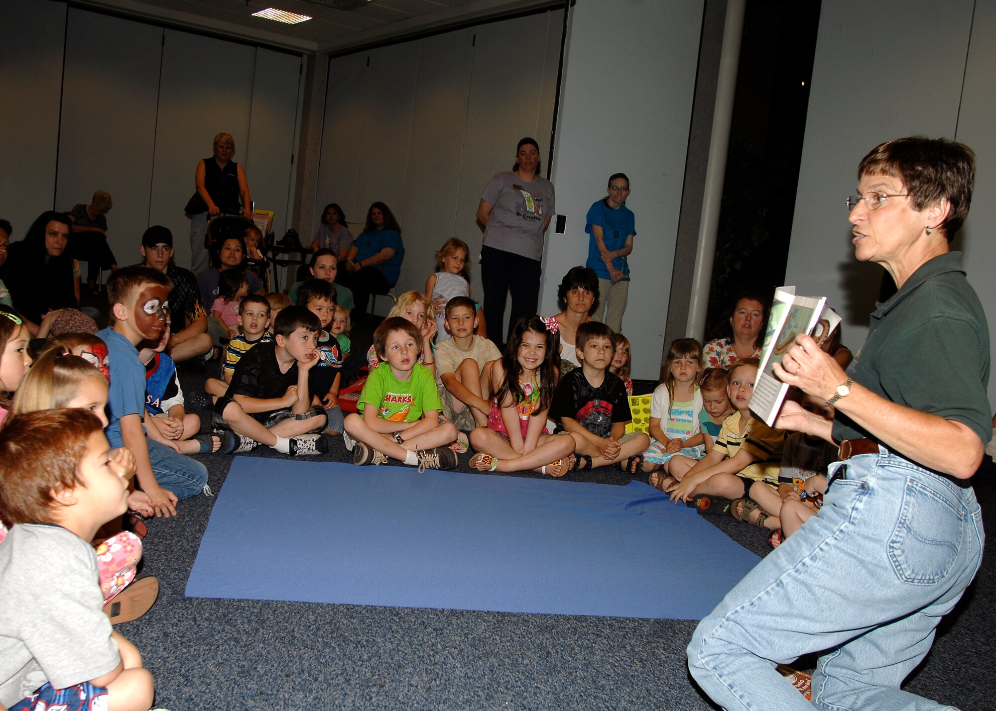 MCCONNELL AIR FORCE BASE, Kan. -- Joyce Lent, from the Great Plains Nature Center, shows a nature book to the story time children in the Robert J. Dole Community Center Heritage room, June 9. Story time provides the children to learn about a wide variety of animals with the books. (Photo by Senior Airman Anthony Mejia)