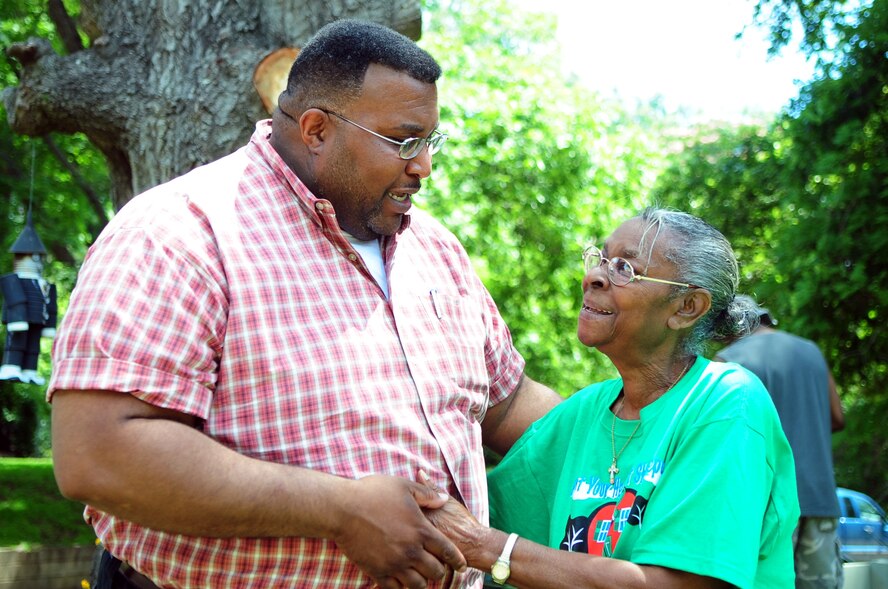 BARKSDALE AIR FORCE BASE, La. -- Mayor of Shreveport Cedric Glover greets homeowner Earnestine Ford outside her home during the Paint Your Heart Out Shreveport event held June 6. Mrs. Ford’s home was painted by Airmen from the 2d Force Support Squadron and the 26th Operational Weather Squadron. (U.S. Air Force photo by Senior Airman Joanna M. Kresge)
