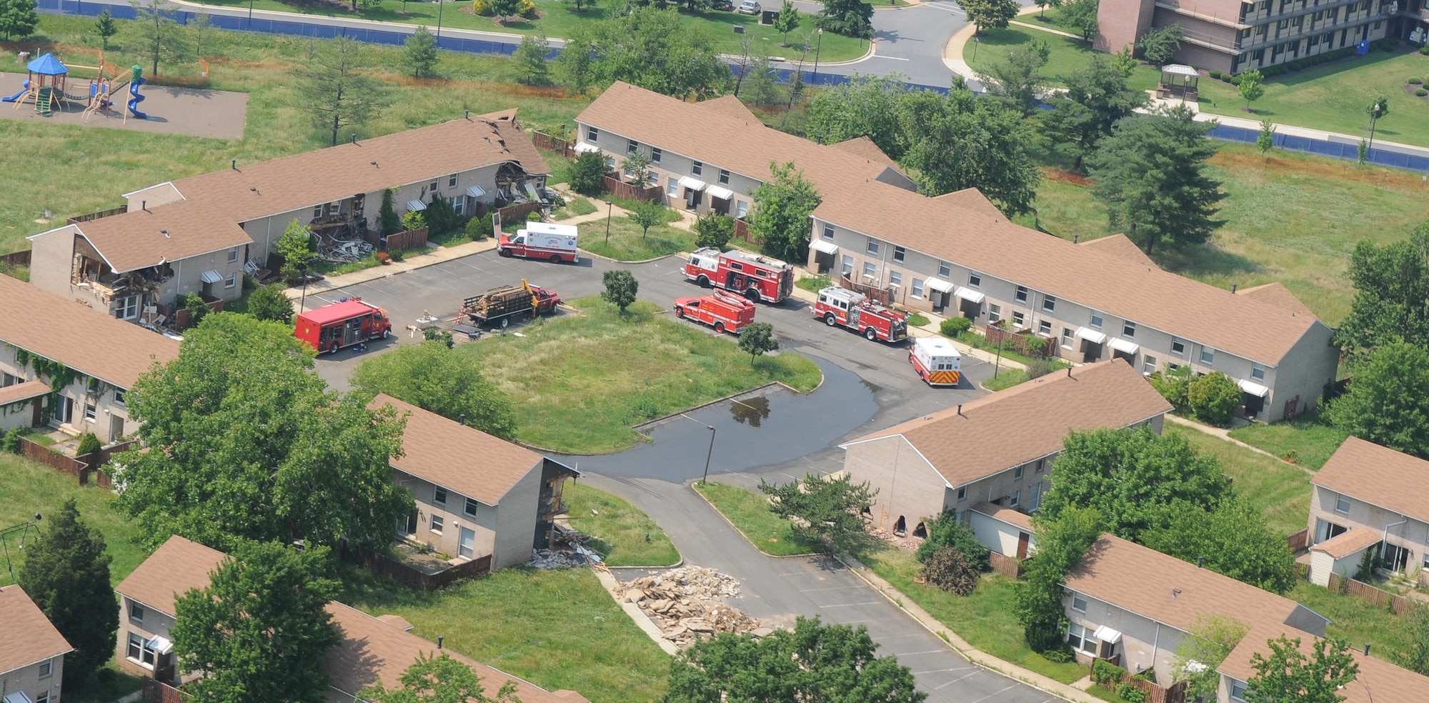 An aerial view of vehicles from Naval District of Washington Fire Department and District of Columbia Fire Department June 8 on Bolling Air Force Base. The coming demolition of Hickam Village housing created a prime location and opportunity June 1 - 12 for a joint fire department training effort. (U.S. Air Force photo by Senior Airman Alexandre Montes)
