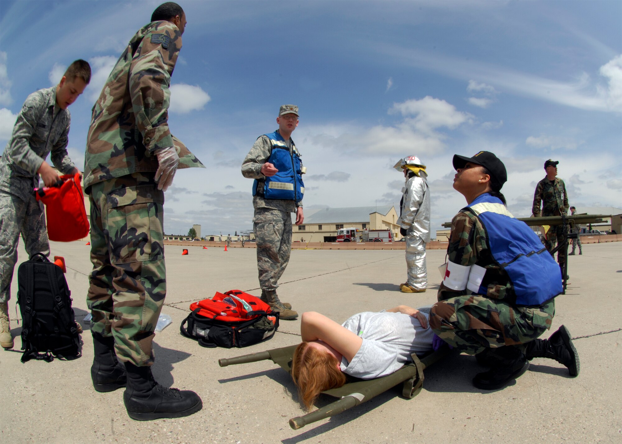 MINOT AIR FORCE BASE, -- Emergency personnel respond to an “injured victim” during a major accident response exercise here, Jun 5.  The simulation was conducted in preparation for the air show and open house, Northern Neighbors Day.  2009 was a year that brought progress and a renewed emphasis on safe, secure and reliable nuclear operations. The 91st Missile Wing transitioned to Air Force Global Strike Command with the 5th Bomb Wing scheduled to follow suit in 2010. (U.S. Air Force Photo by Staff Sgt. Miguel Lara III)