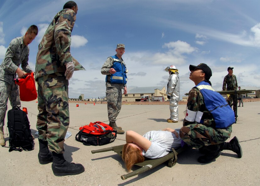MINOT AIR FORCE BASE, -- Emergency personnel respond to an “injured victim” during a major accident response exercise here, Jun 5.  The simulation was conducted in preparation for the air show and open house, Northern Neighbors Day.  2009 was a year that brought progress and a renewed emphasis on safe, secure and reliable nuclear operations. The 91st Missile Wing transitioned to Air Force Global Strike Command with the 5th Bomb Wing scheduled to follow suit in 2010. (U.S. Air Force Photo by Staff Sgt. Miguel Lara III)