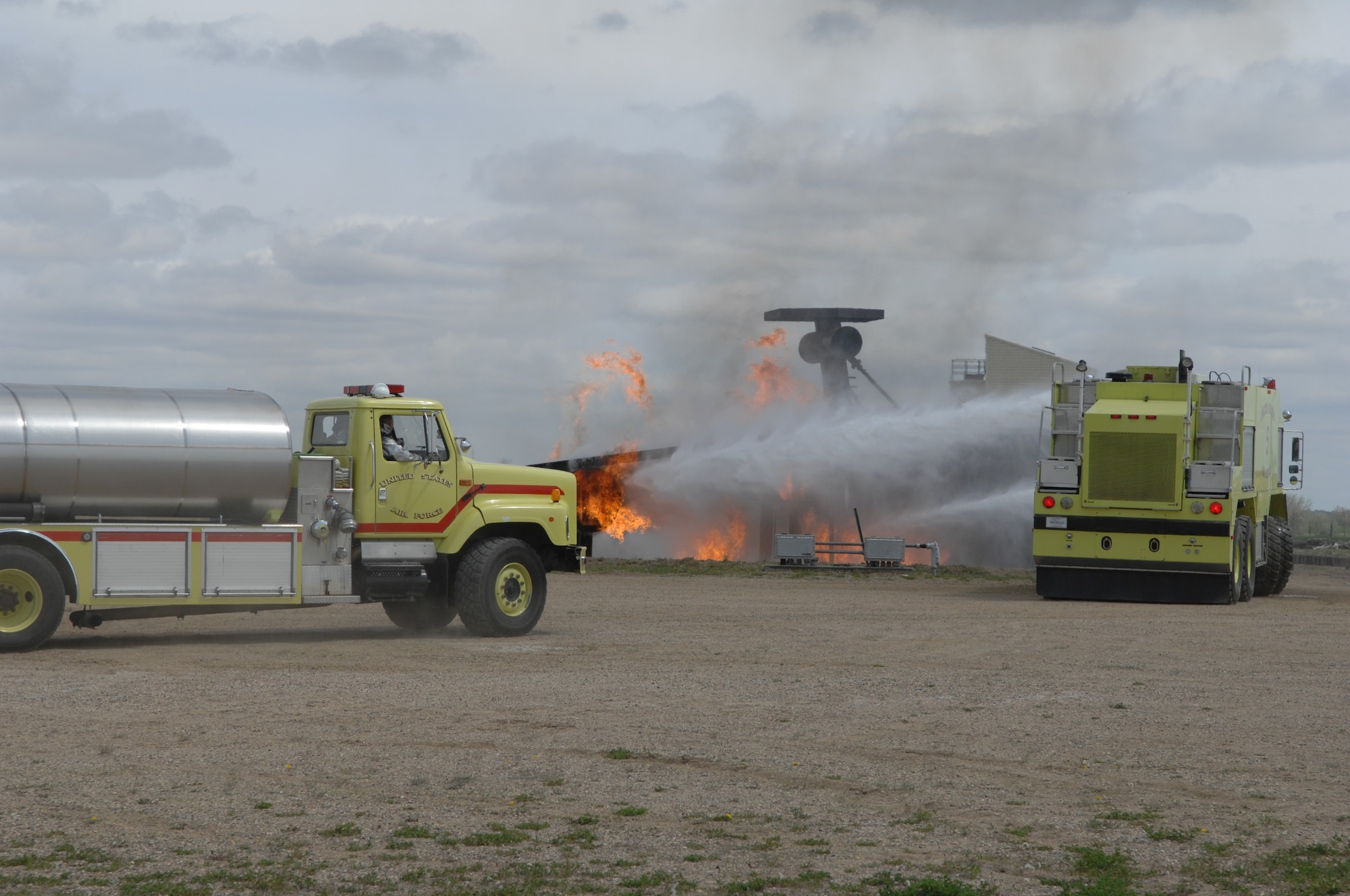 MINOT AIR FORCE BASE, ND – Members from the 5th Civil Engineer Squadron’s Fire Department extinguishes the flames on a simulated crashed plane during a major accident response exercise (MARE) here, June 5.  The exercise was held to further strengthen the base’s ability to respond to an aerial accident, in preparation for the upcoming air show and open house, Northern Neighbors Day, scheduled for July 18 here.  (U.S. Air Force photo by Staff Sgt. Angel Gallardo)